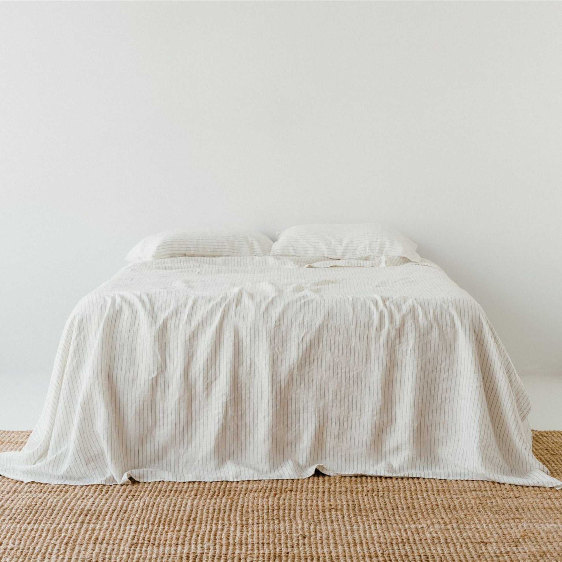 Foxtrot Home French Flax Linen styled in a bedroom with Coastal Blue Stripes Fitted Sheet