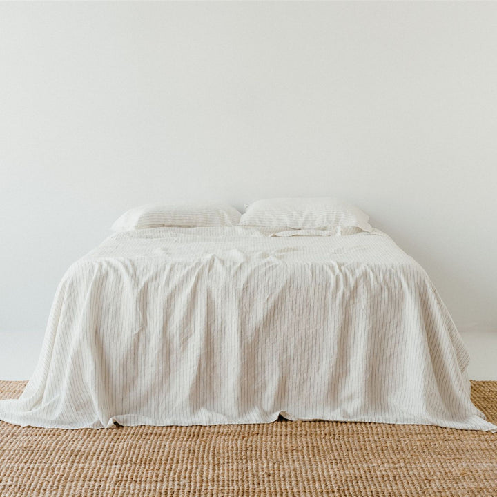 Foxtrot Home French Flax Linen styled in a bedroom with Coastal Blue Stripes Fitted Sheet