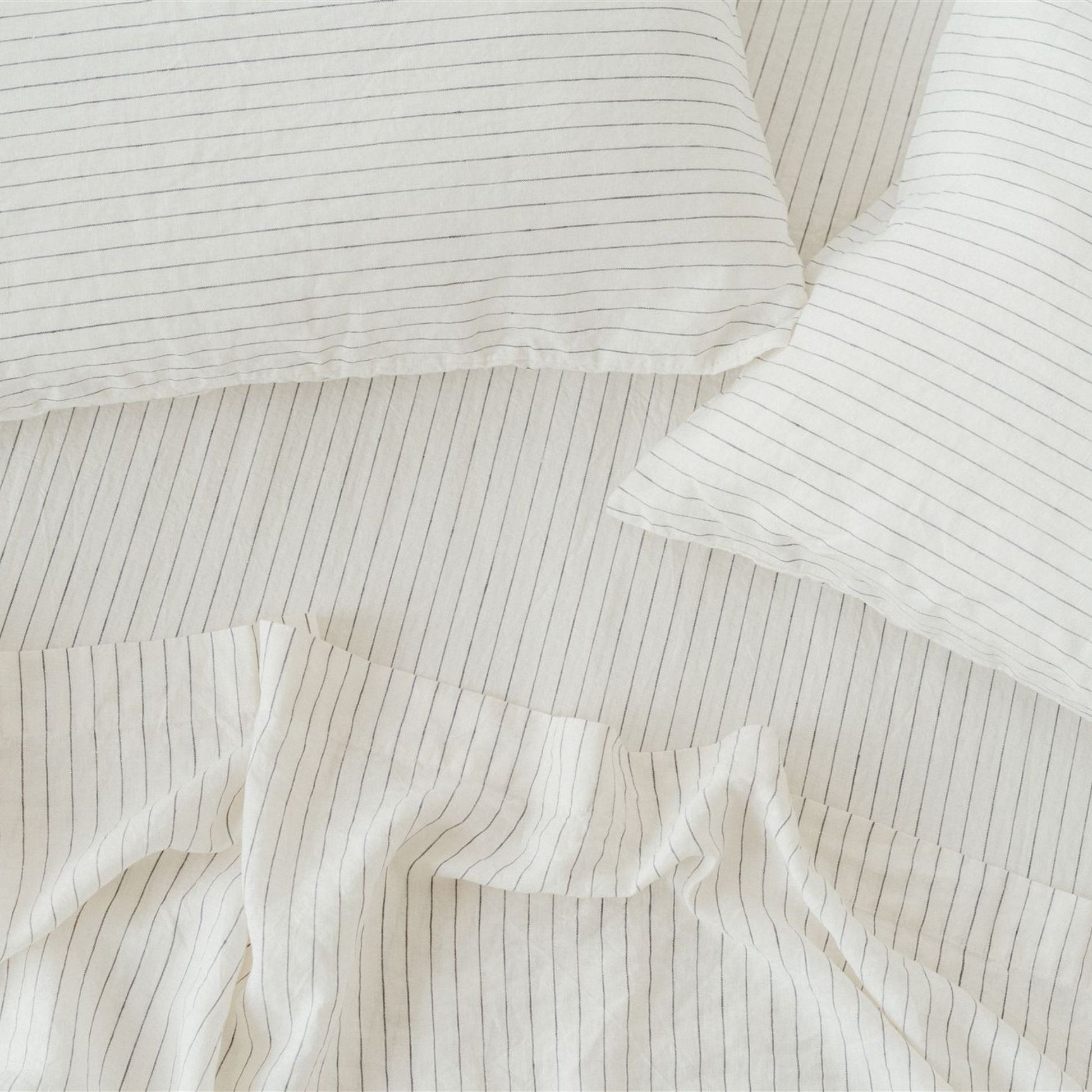 Foxtrot Home French Flax Linen styled in a bedroom with Coastal Blue Stripes Fitted Sheet