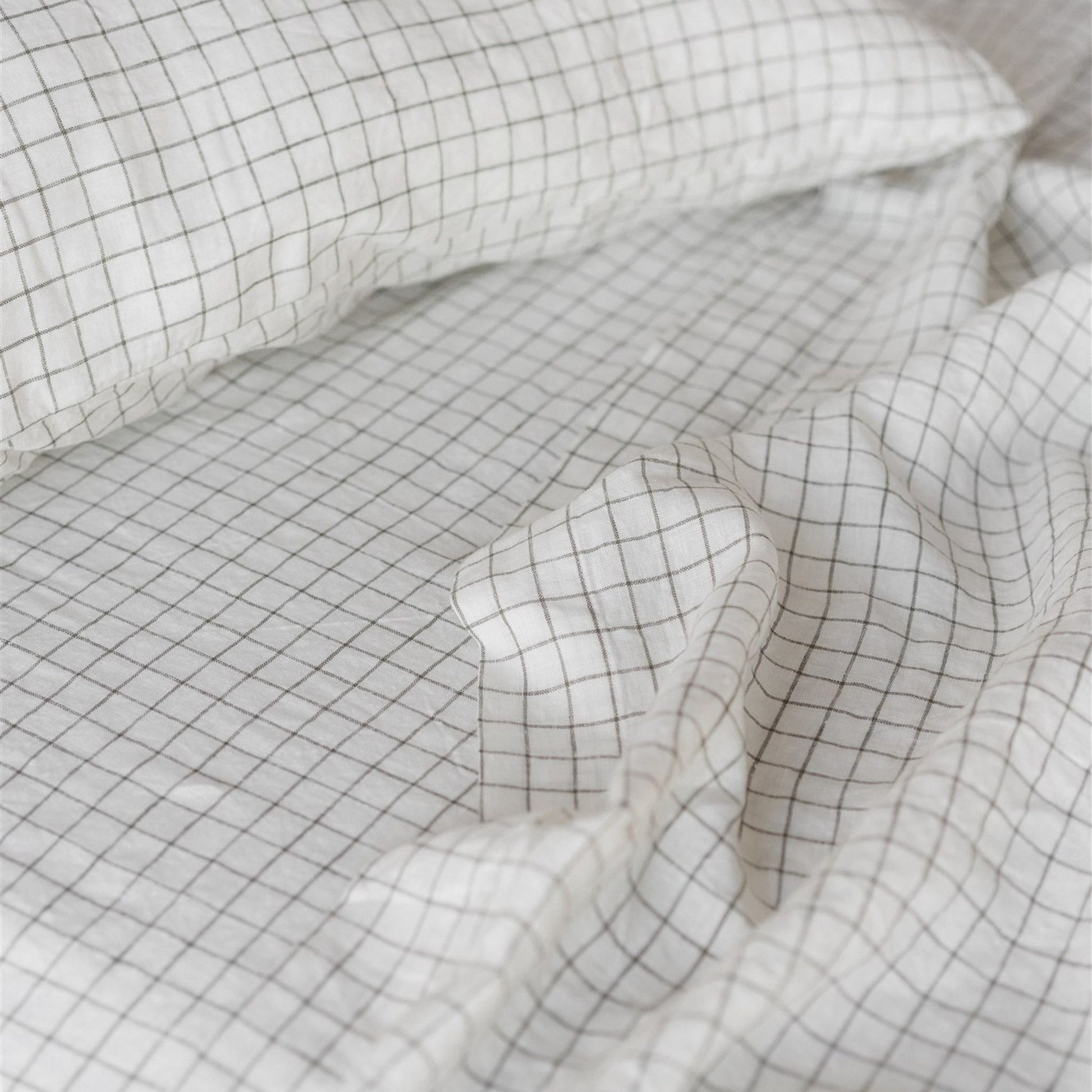 Foxtrot Home French Flax Linen styled in a bedroom with Cactus Grid Fitted Sheet.