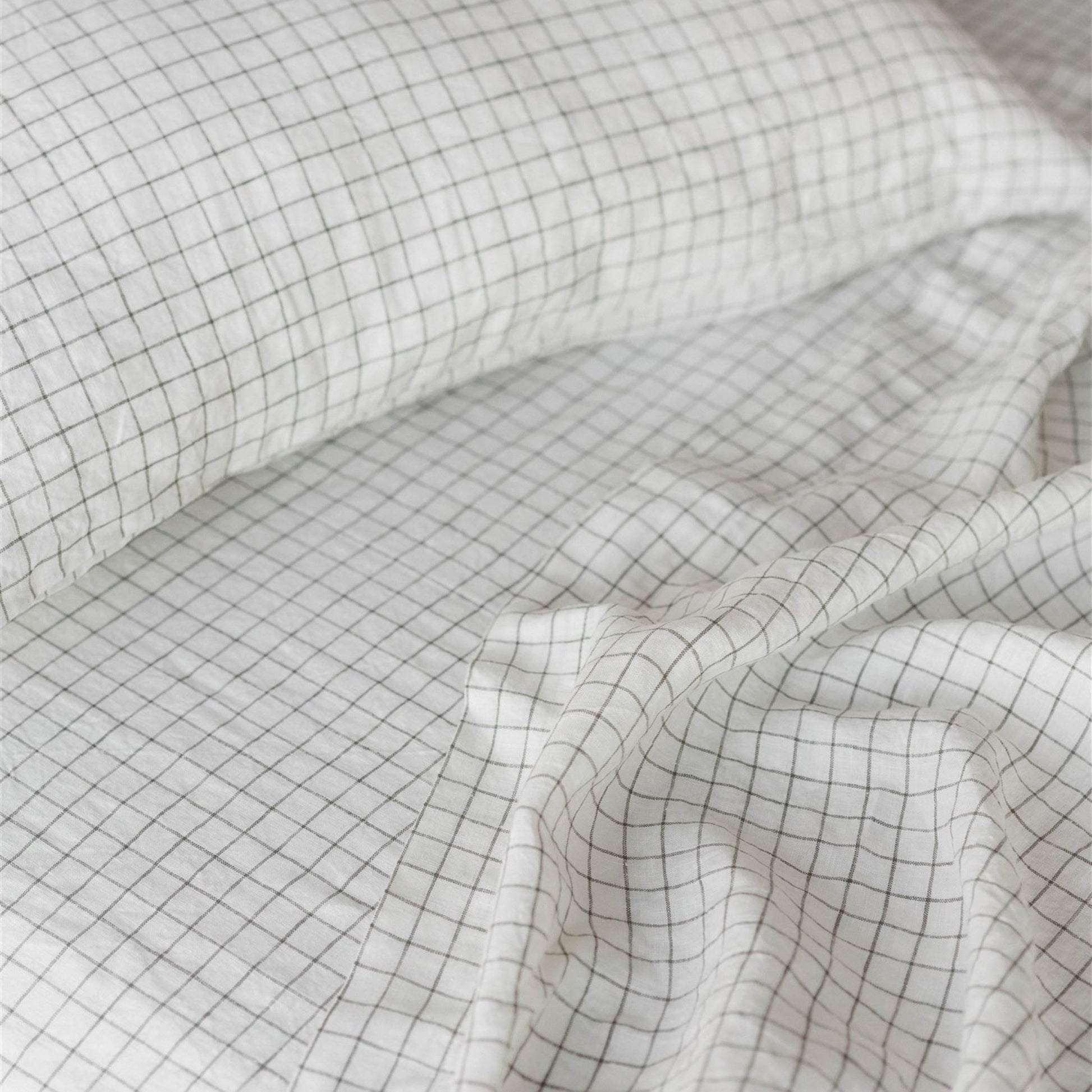 Foxtrot Home French Flax Linen styled in a bedroom with Cactus Grid Fitted Sheet.