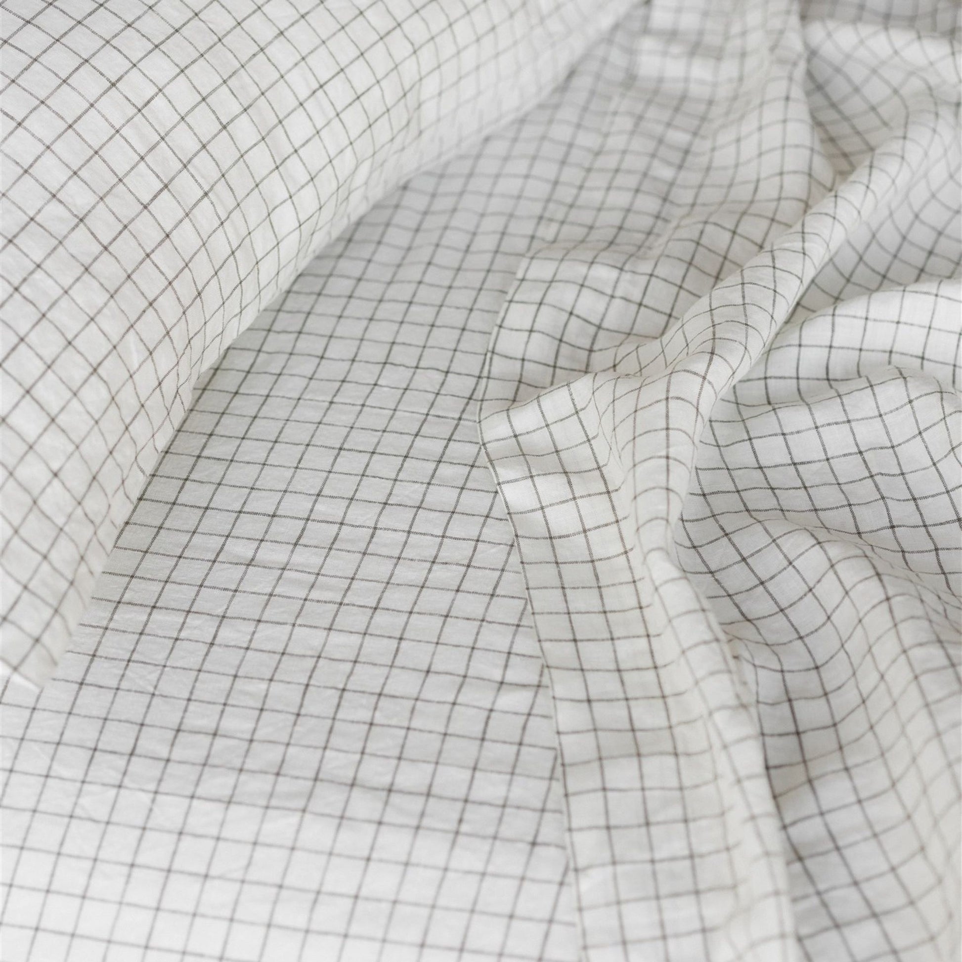 Foxtrot Home French Flax Linen styled in a bedroom with Cactus Grid Fitted Sheet.