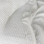 Foxtrot Home French Flax Linen styled in a bedroom with Cactus Grid Fitted Sheet.