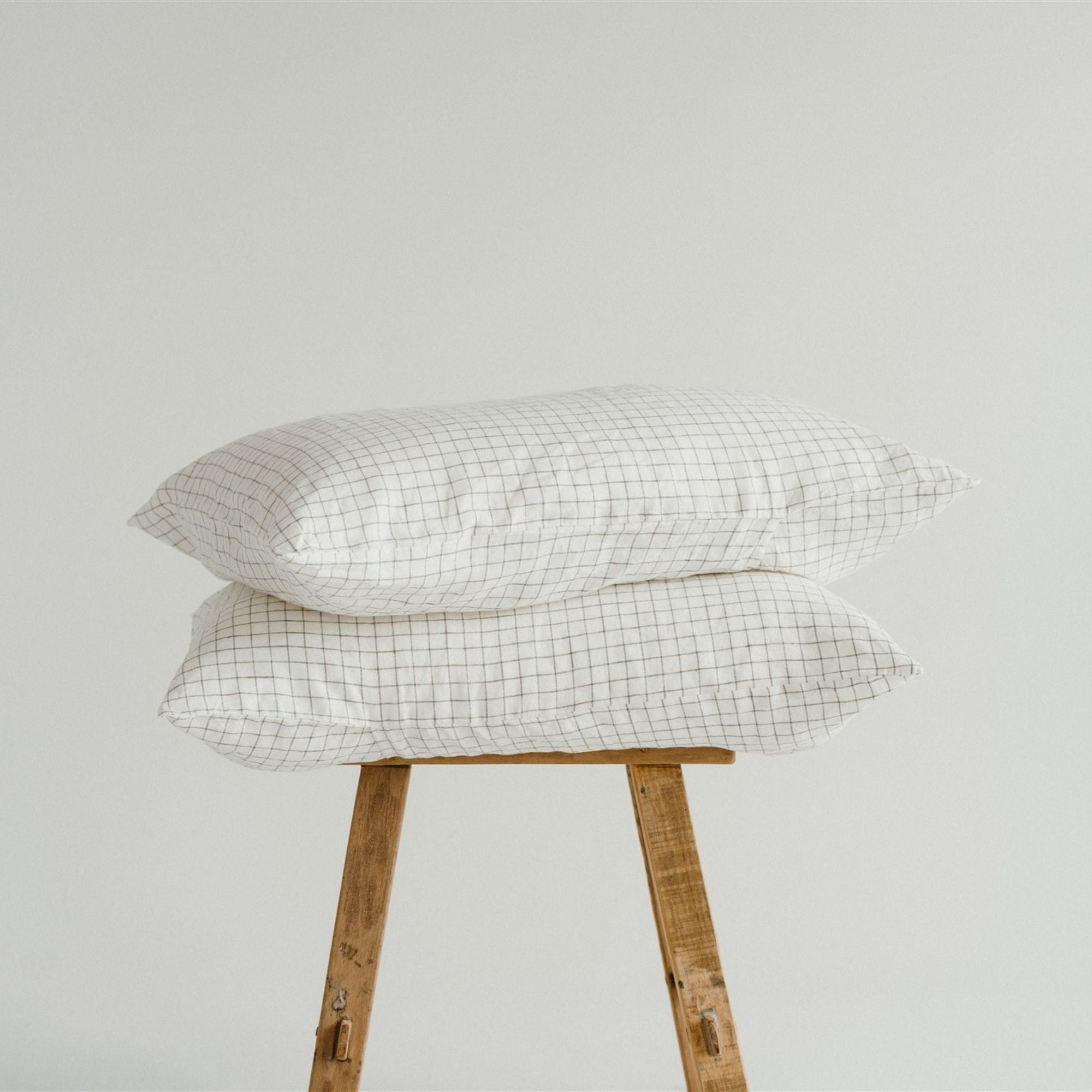 Foxtrot Home French Flax Linen styled in a bedroom with Cactus Grid Pillowcases.