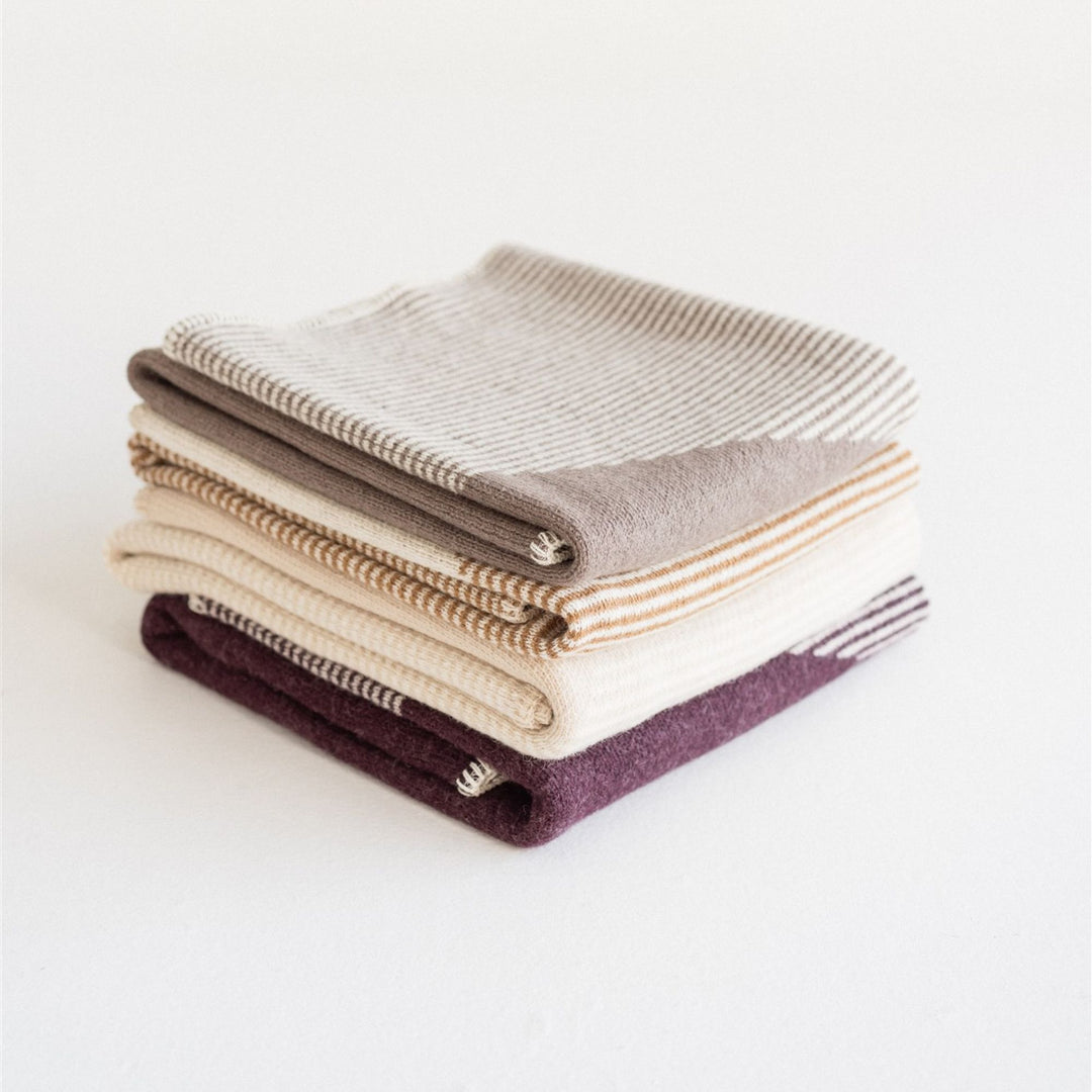 Foxtrot Home New Zealand Wool Throw Blankets in Geometric pattern stacked in four colours, Fig Pampas Ginger Honey and Mushroom