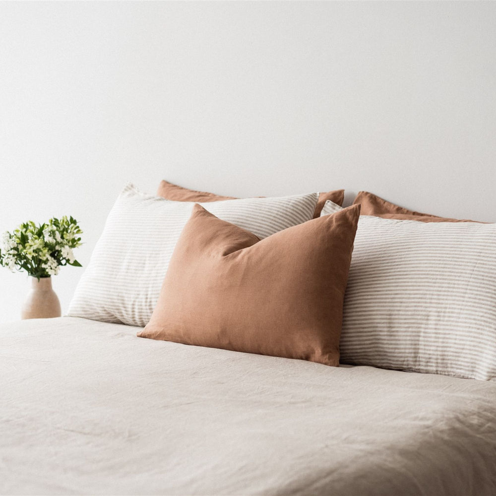 Foxtrot Home French Flax Linen styled in a bedroom with Malt Brown Rectangle Cushion Cover.