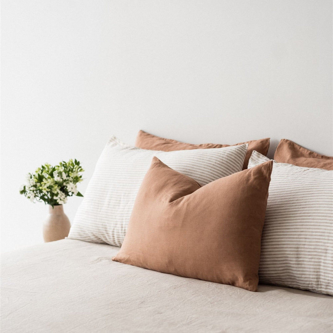 Foxtrot Home French Flax Linen styled in a bedroom with Malt Brown Rectangle Cushion Cover.