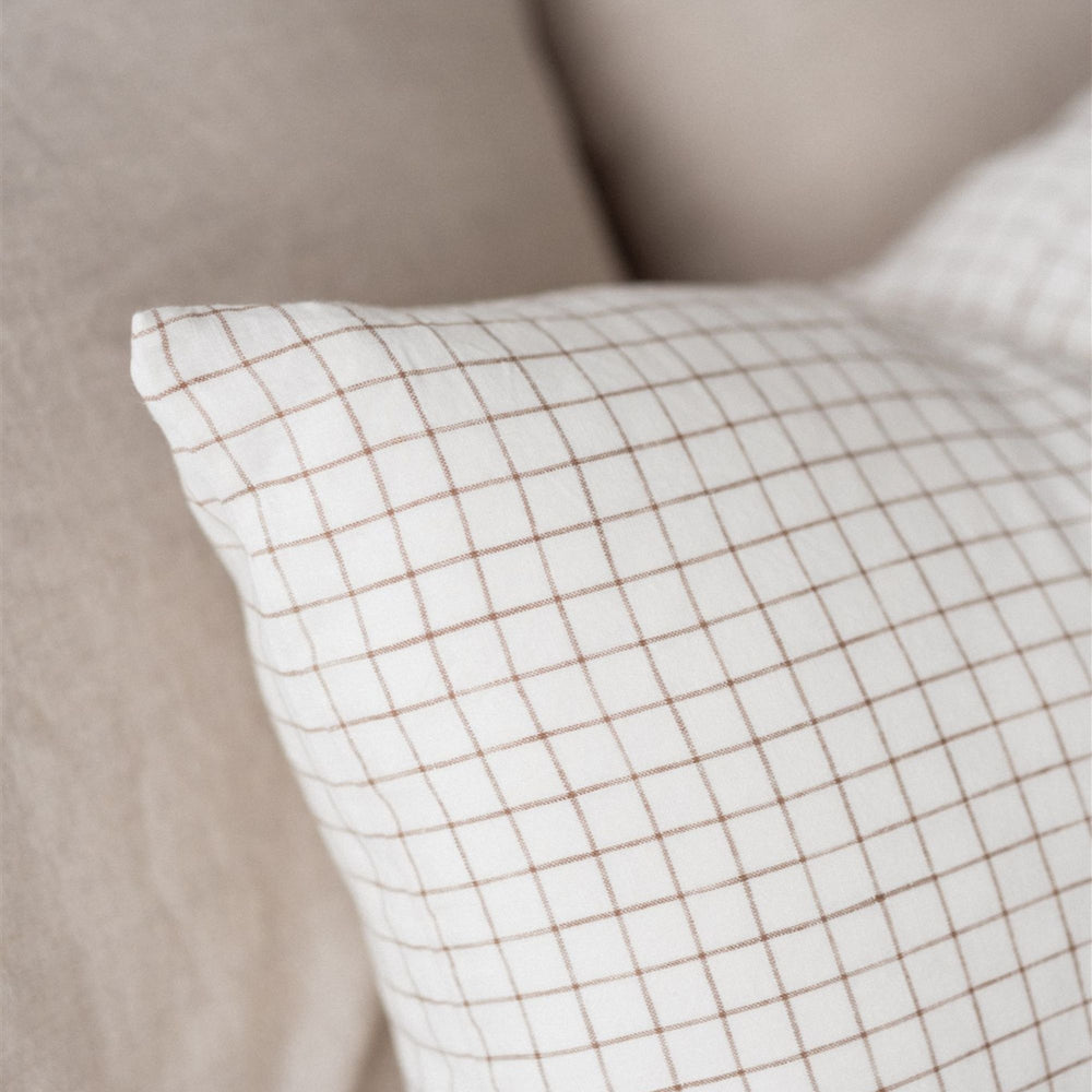 Foxtrot Home French Flax Linen styled in a bedroom with Malt Brown Grid Rectangle Cushion Cover.