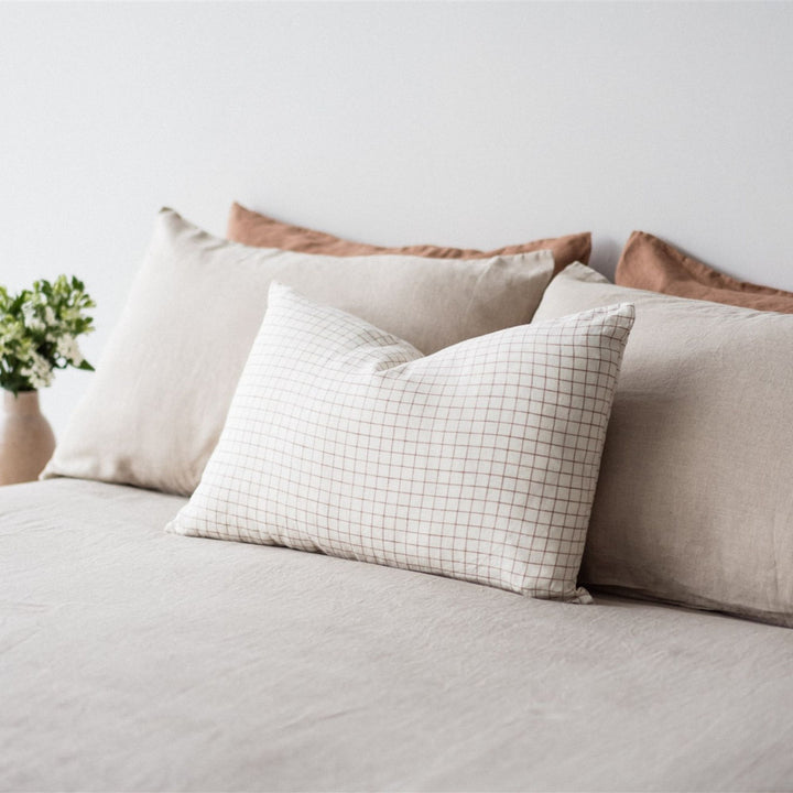 Foxtrot Home French Flax Linen styled in a bedroom with Malt Brown Grid Rectangle Cushion Cover.