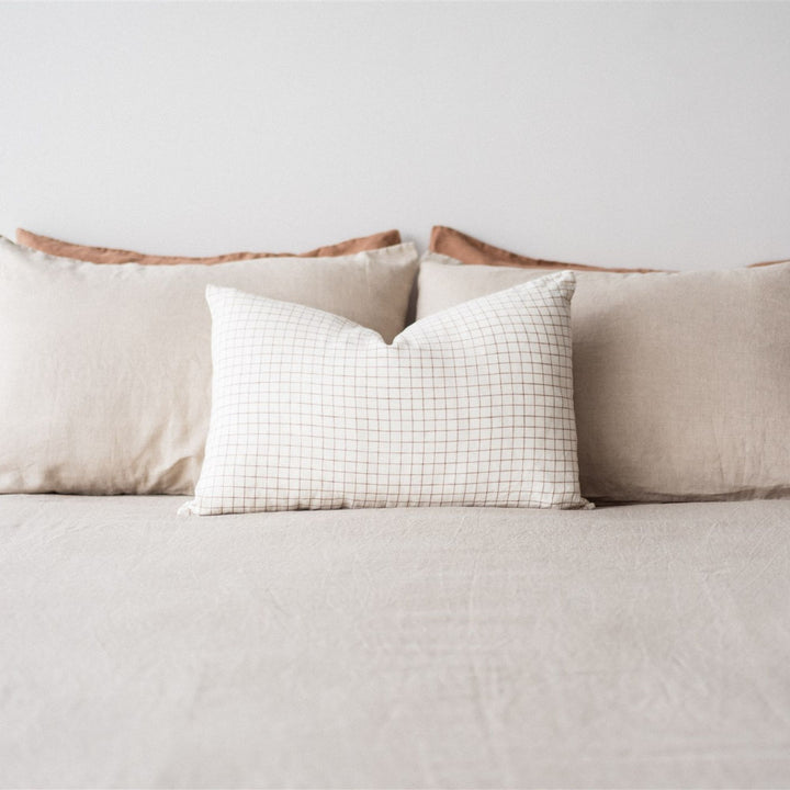 Foxtrot Home French Flax Linen styled in a bedroom with Malt Brown Grid Rectangle Cushion Cover.