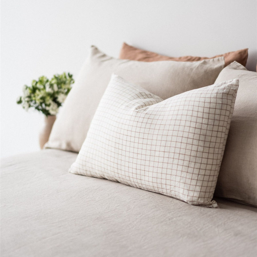 Foxtrot Home French Flax Linen styled in a bedroom with Malt Brown Grid Rectangle Cushion Cover.