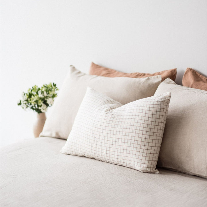 Foxtrot Home French Flax Linen styled in a bedroom with Malt Brown Grid Rectangle Cushion Cover.