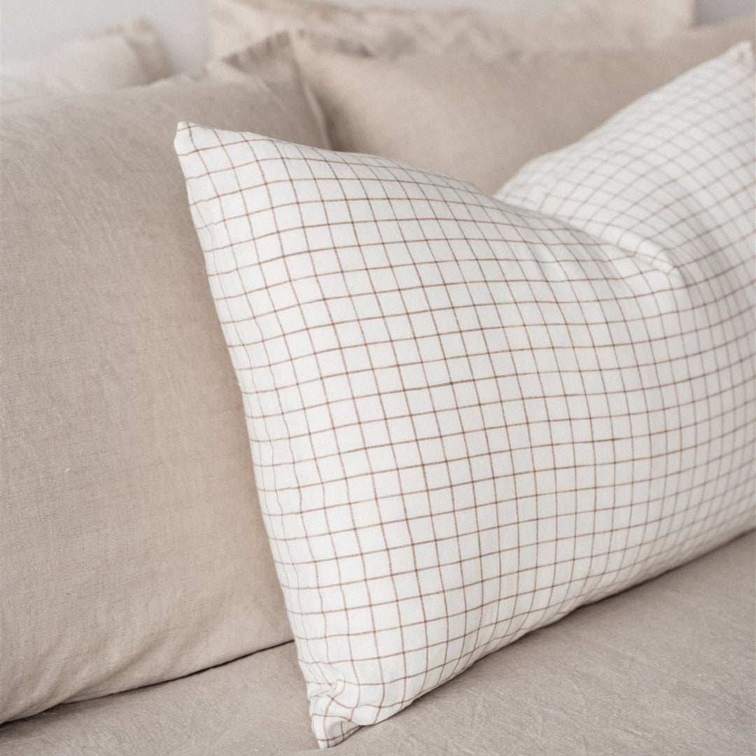 Foxtrot Home French Flax Linen styled in a bedroom with Malt Brown Grid Rectangle Cushion Cover.