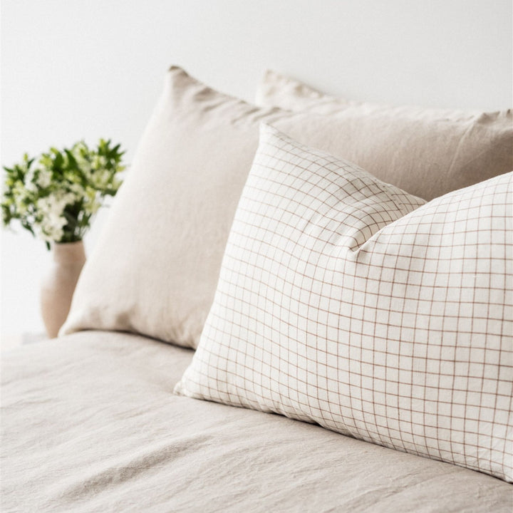 Foxtrot Home French Flax Linen styled in a bedroom with Malt Brown Grid Rectangle Cushion Cover.