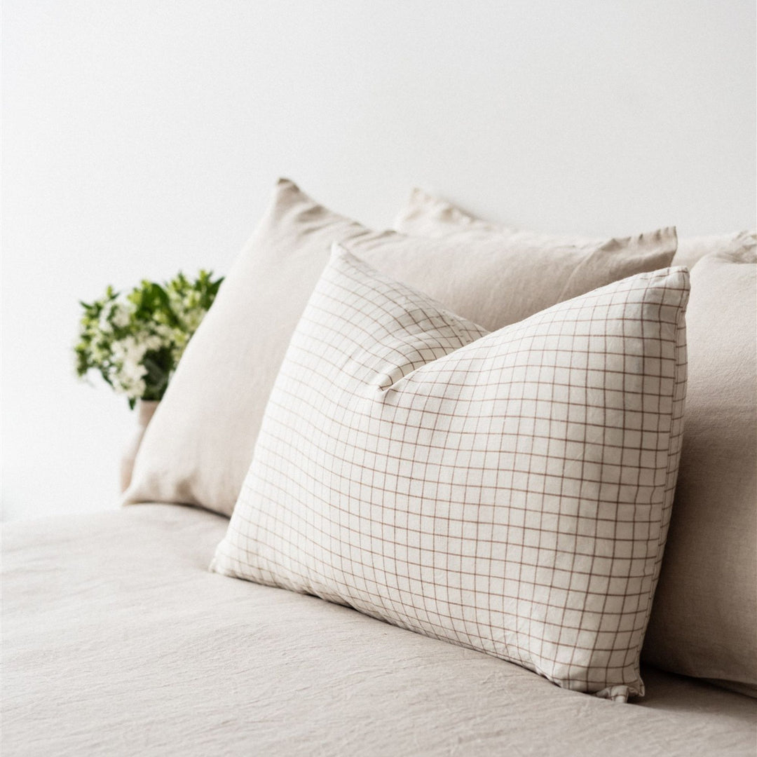 Foxtrot Home French Flax Linen styled in a bedroom with Malt Brown Grid Rectangle Cushion Cover.