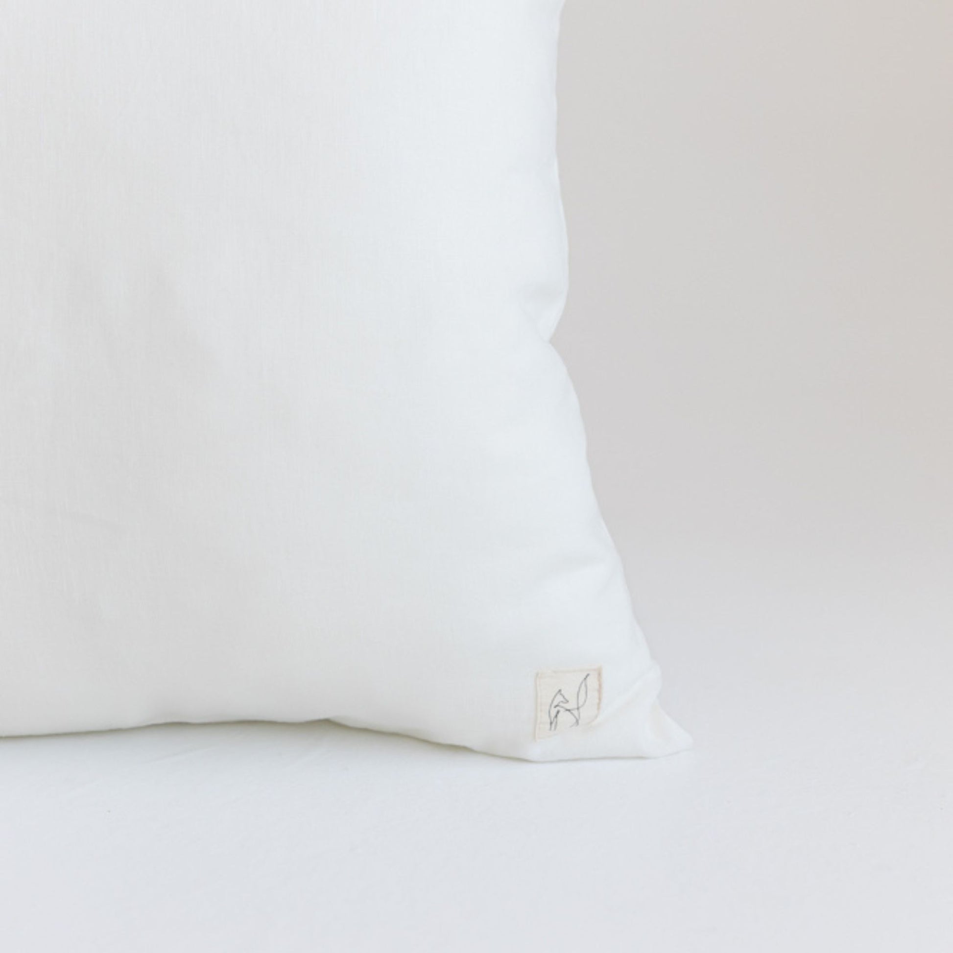 Foxtrot Home French Flax Linen styled in a bedroom with Off White Cushion Cover.