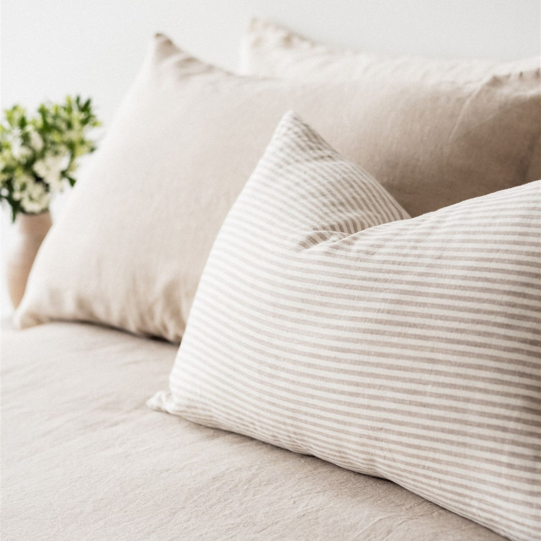 Foxtrot Home French Flax Linen styled in a bedroom with Sand Stripes Rectangle Cushion Cover.