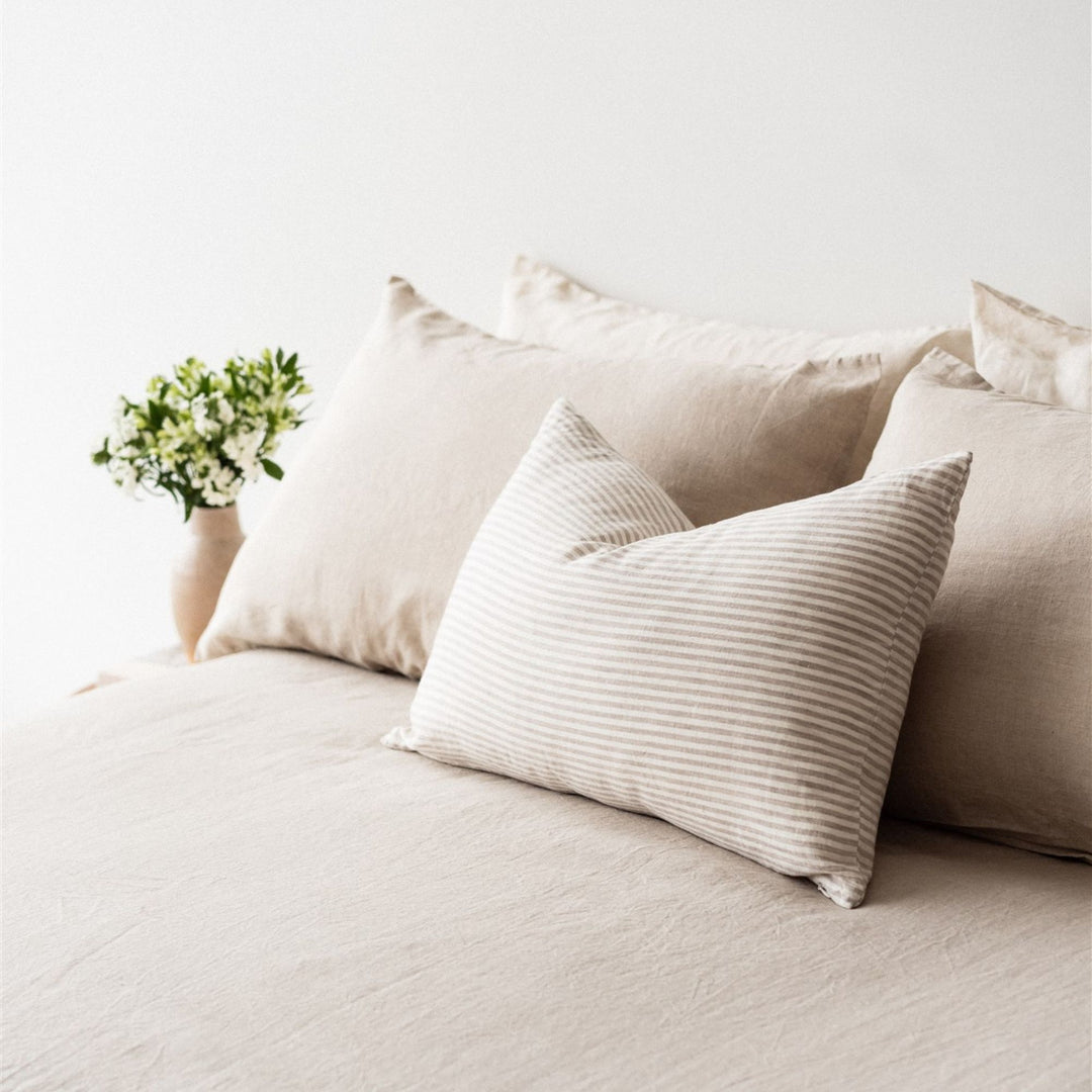 Foxtrot Home French Flax Linen styled in a bedroom with Sand Stripes Rectangle Cushion Cover.