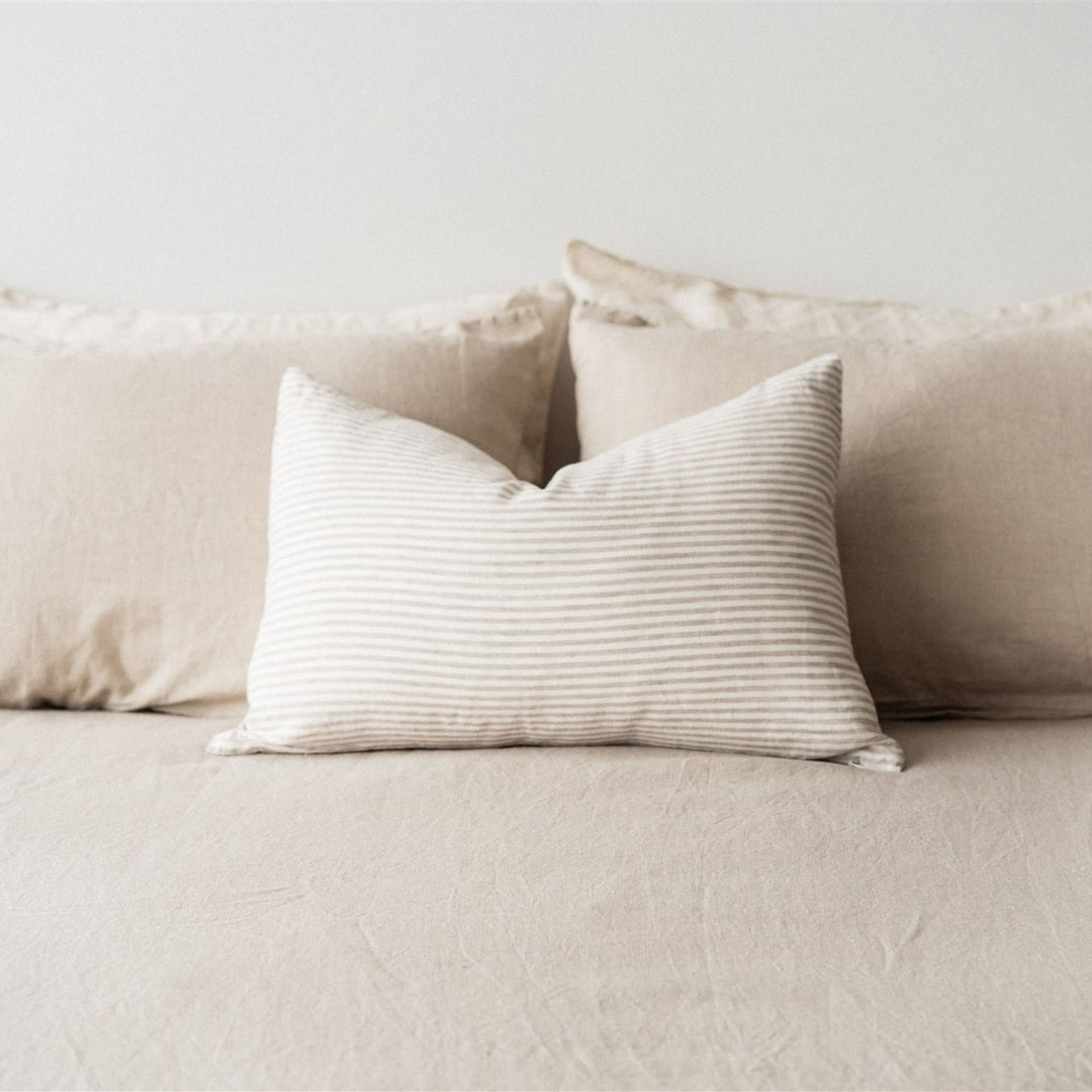 Foxtrot Home French Flax Linen styled in a bedroom with Sand Stripes Rectangle Cushion Cover.