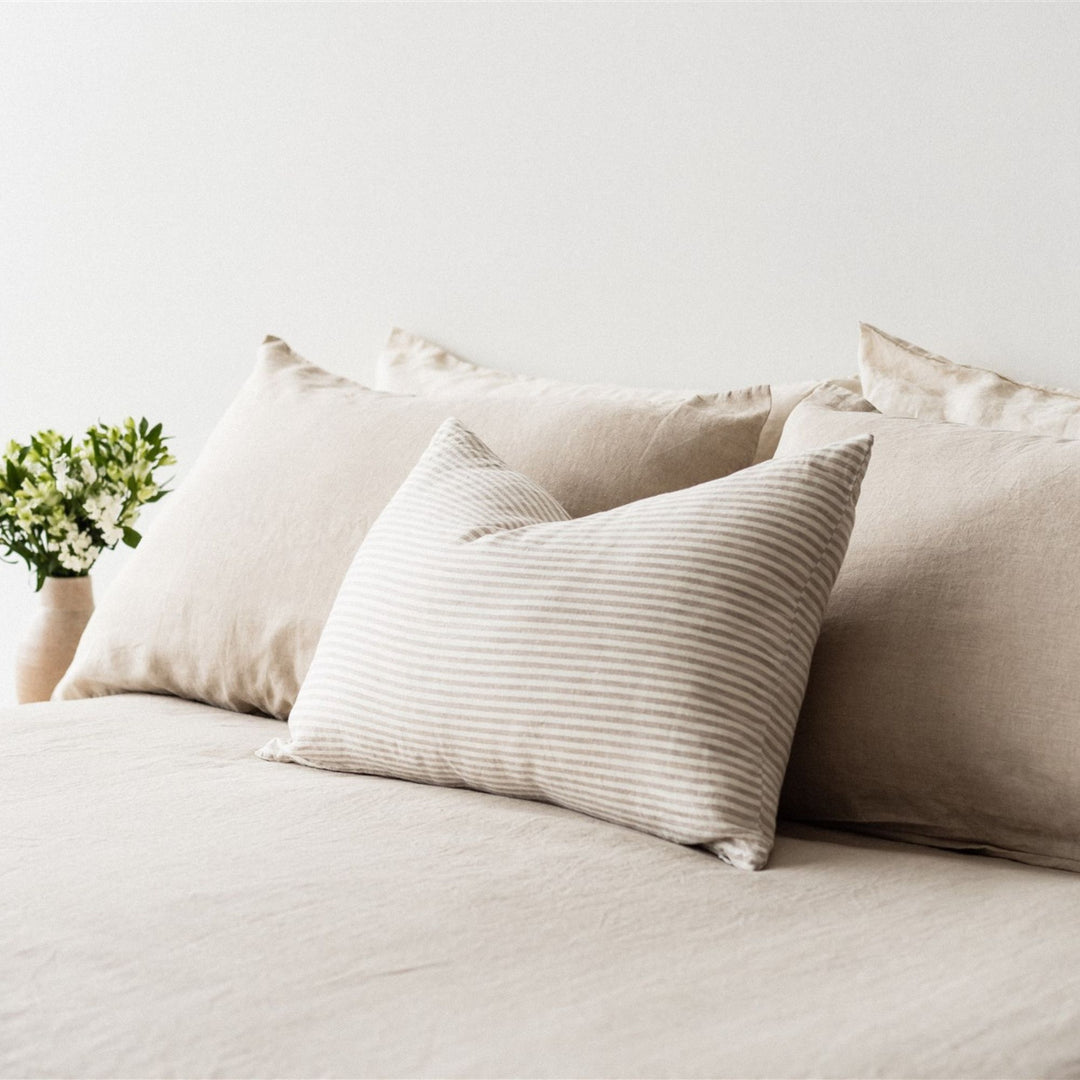 Foxtrot Home French Flax Linen styled in a bedroom with Sand Stripes Rectangle Cushion Cover.