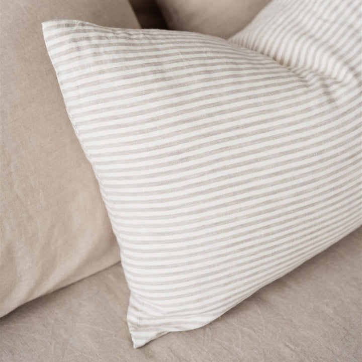 Foxtrot Home French Flax Linen styled in a bedroom with Sand Stripes Rectangle Cushion Cover.