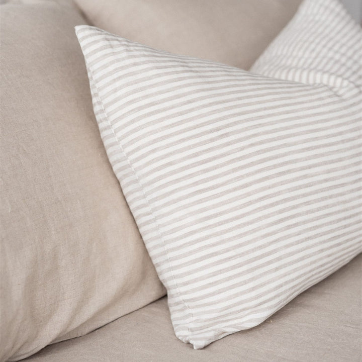 Foxtrot Home French Flax Linen styled in a bedroom with Sand Stripes Rectangle Cushion Cover.