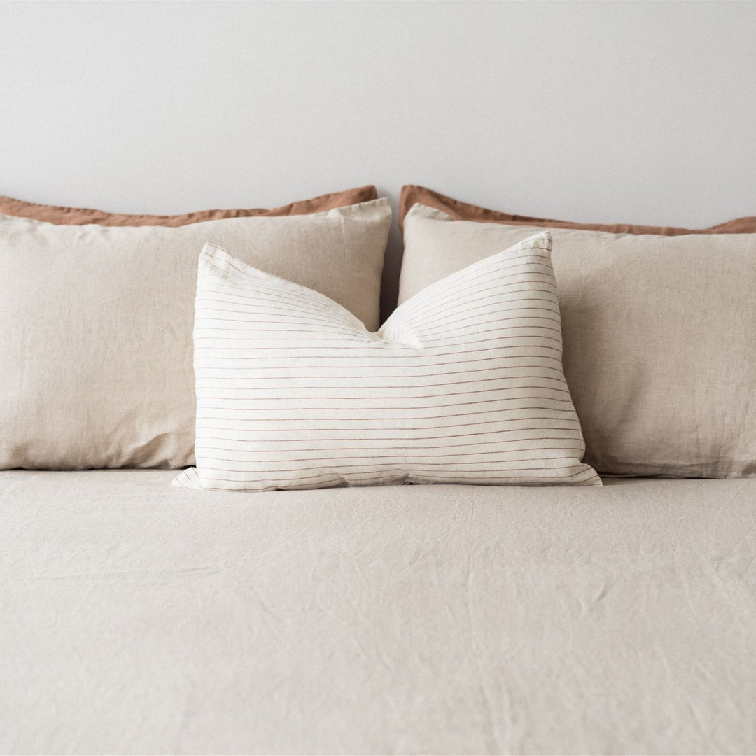 Foxtrot Home French Flax Linen styled in a bedroom with Tobacco Stripes Rectangle Cushion Cover.