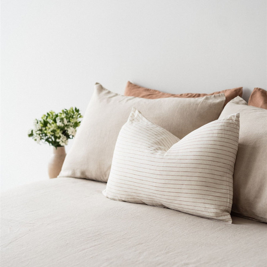 Foxtrot Home French Flax Linen styled in a bedroom with Tobacco Stripes Rectangle Cushion Cover.