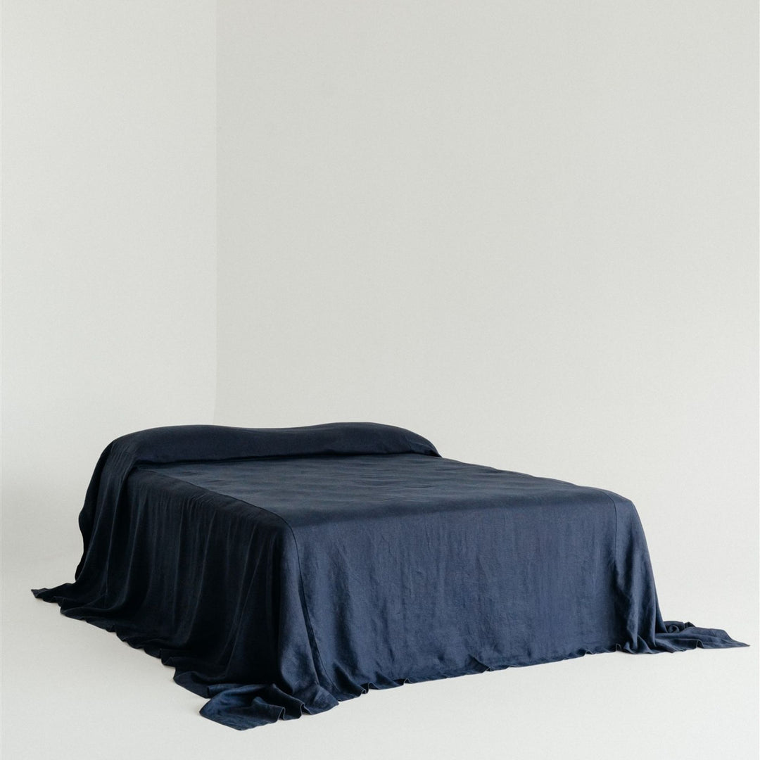 Foxtrot Home French Flax Linen styled in a bedroom with Midnight Blue Bedspread