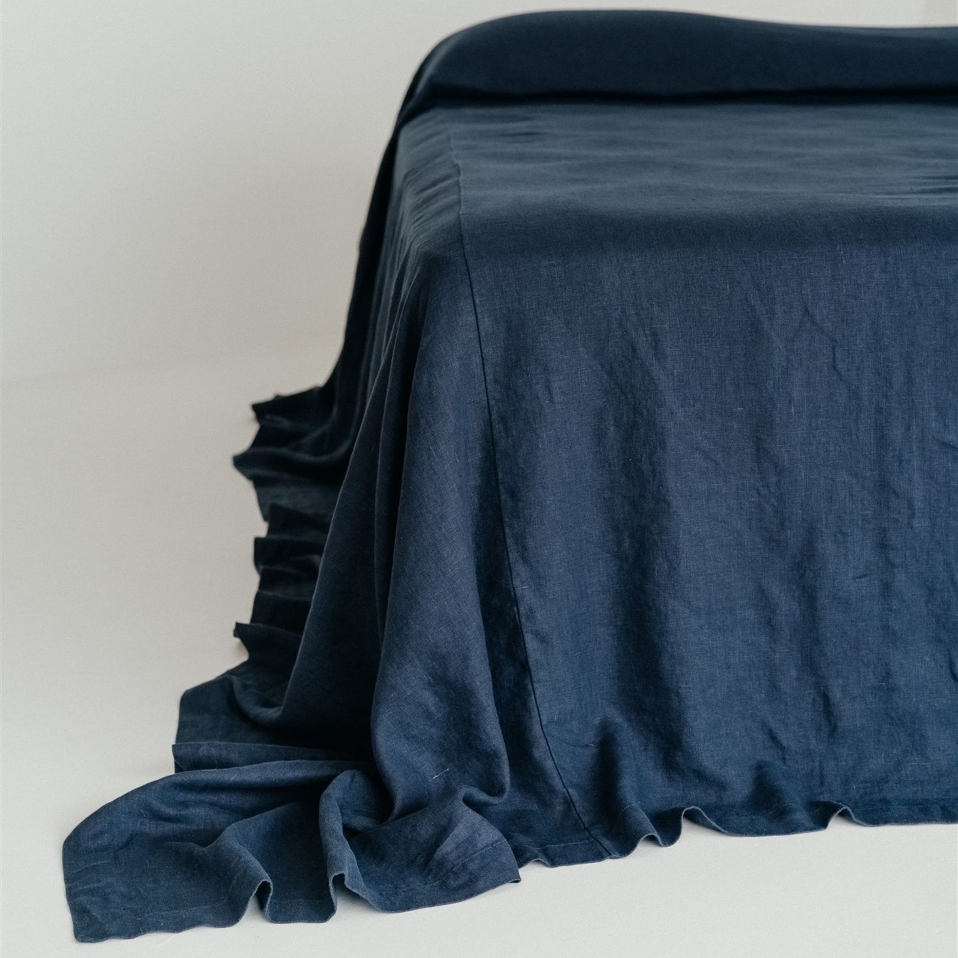 Foxtrot Home French Flax Linen styled in a bedroom with Midnight Blue Bedspread