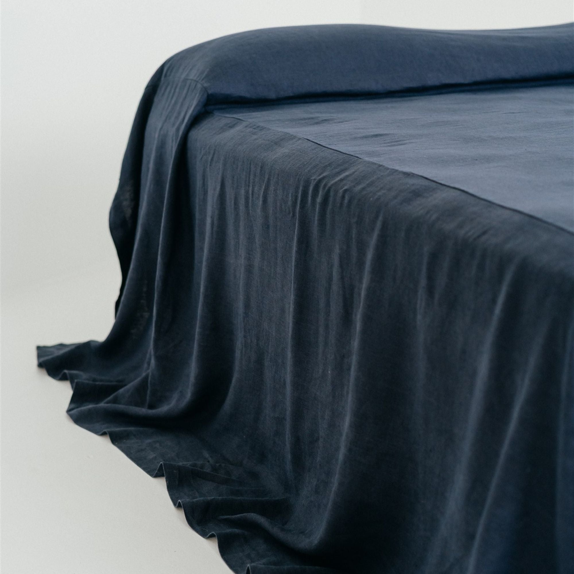 Foxtrot Home French Flax Linen styled in a bedroom with Midnight Blue Bedspread