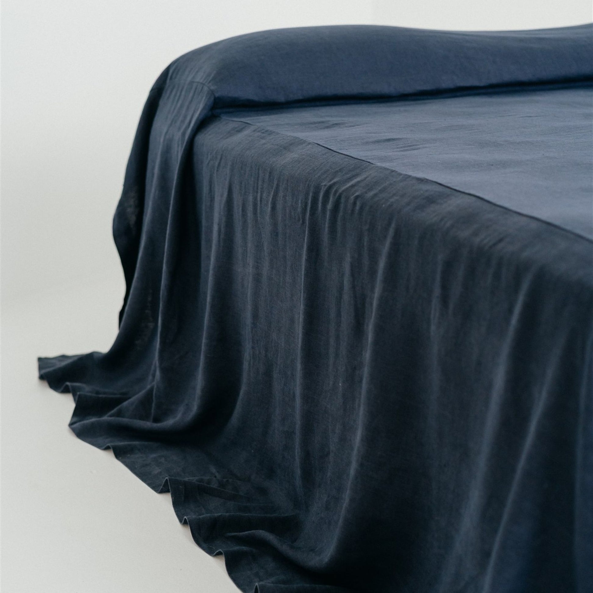 Foxtrot Home French Flax Linen styled in a bedroom with Midnight Blue Bedspread