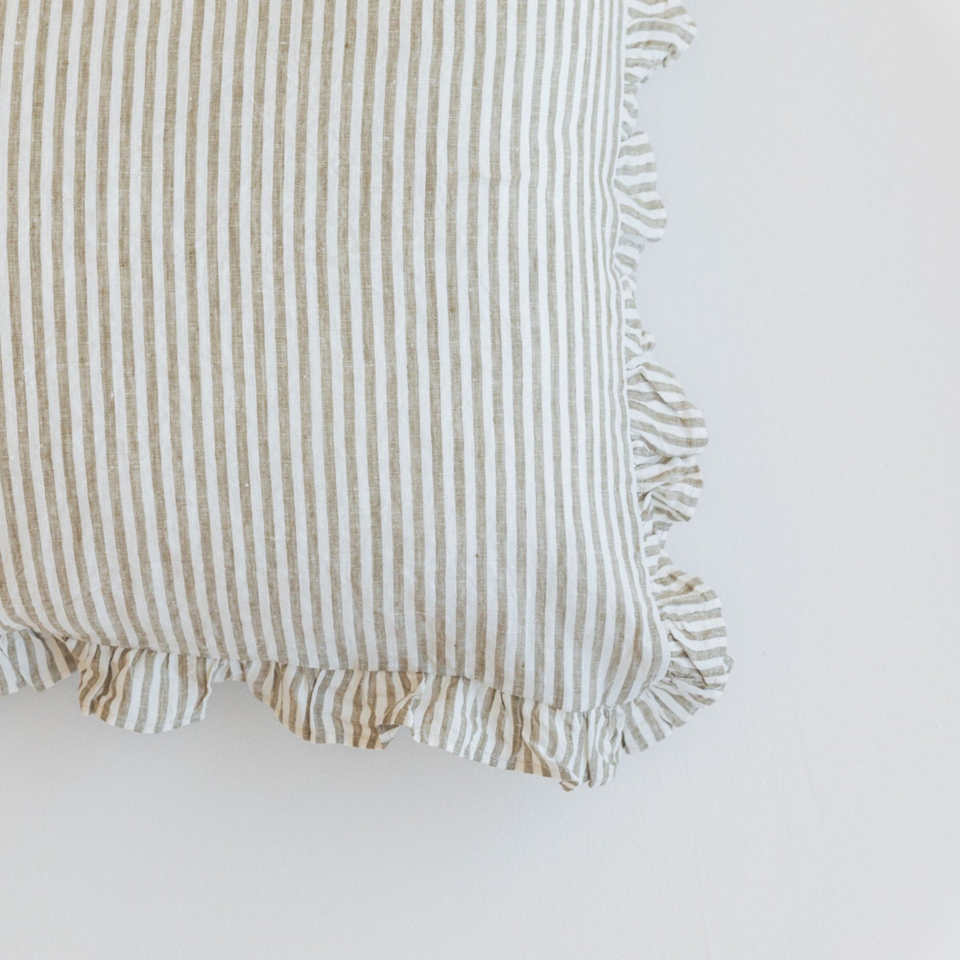 Foxtrot Home French Flax Linen styled in a bedroom with Olive Stripes Stripes Ruffles Cushion Covers