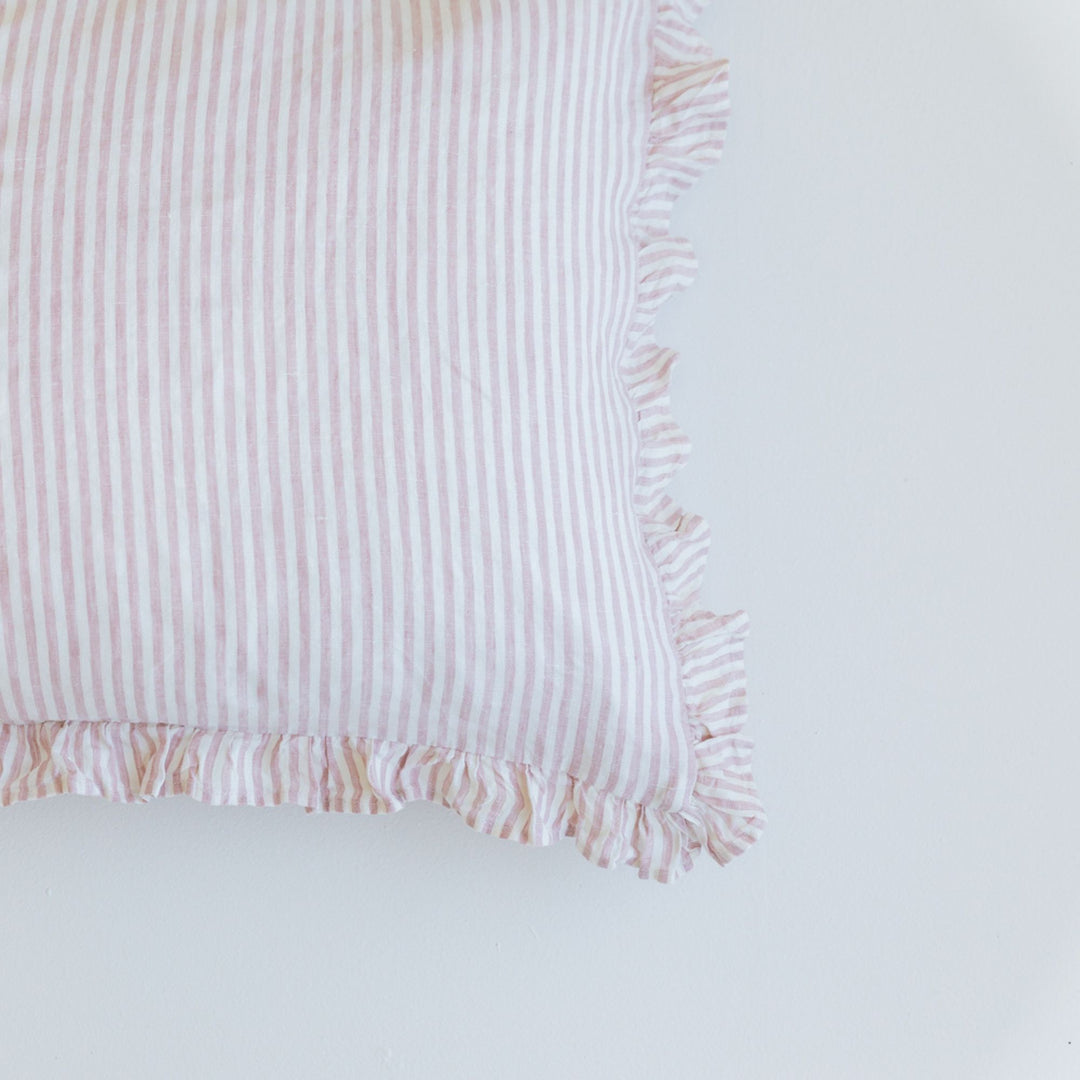Foxtrot Home French Flax Linen styled in a bedroom with a Pink Stripes Ruffles Cushion Cover