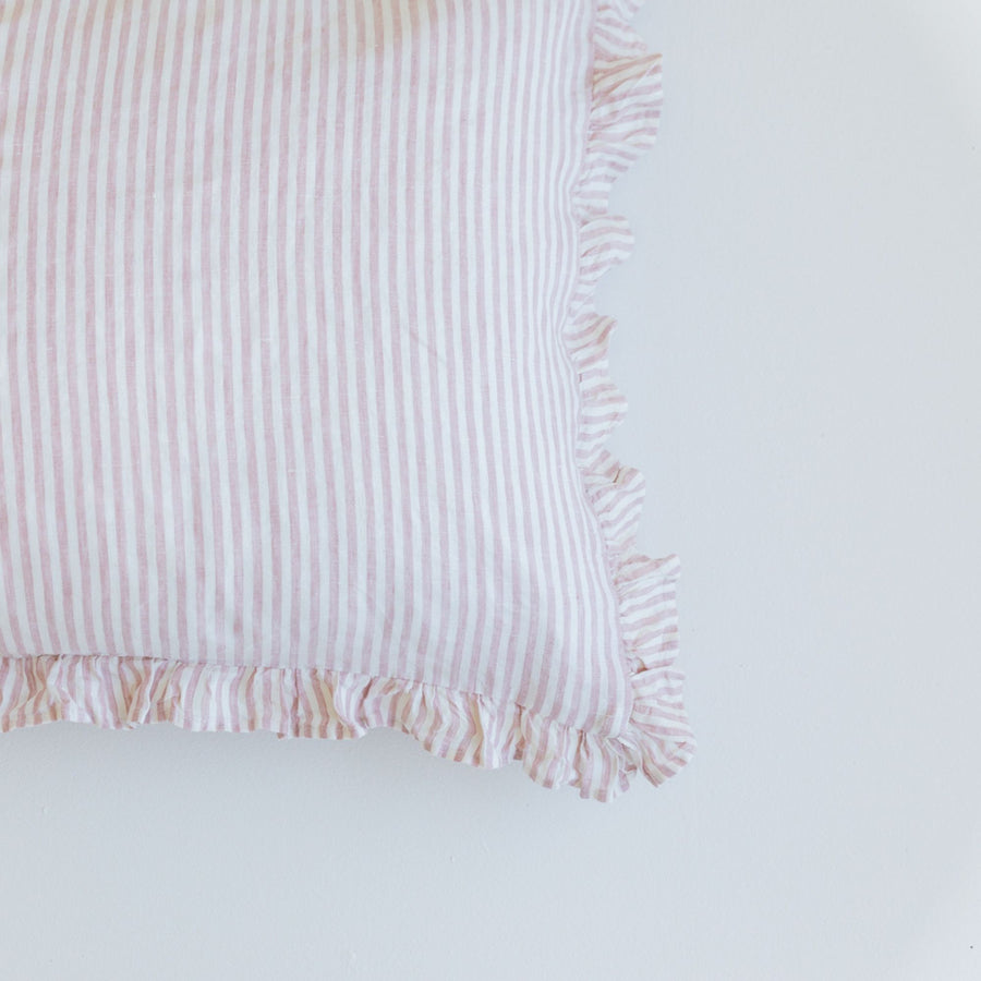 Foxtrot Home French Flax Linen styled in a bedroom with a Pink Stripes Ruffles Cushion Cover