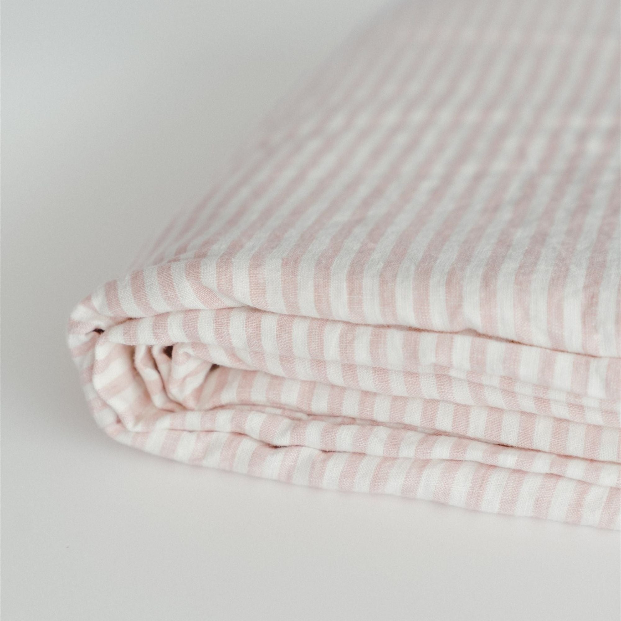Foxtrot Home French Flax Linen styled in a bedroom with Pink Stripes Fitted Sheet.