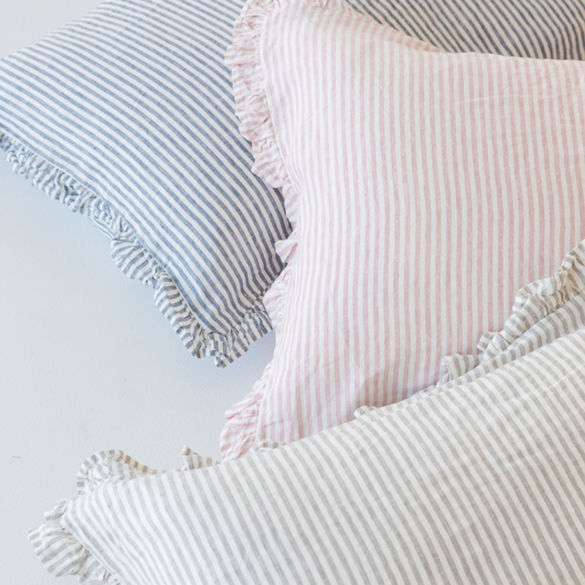 Foxtrot Home French Flax Linen styled in a bedroom with Stripes Ruffles Cushion Covers