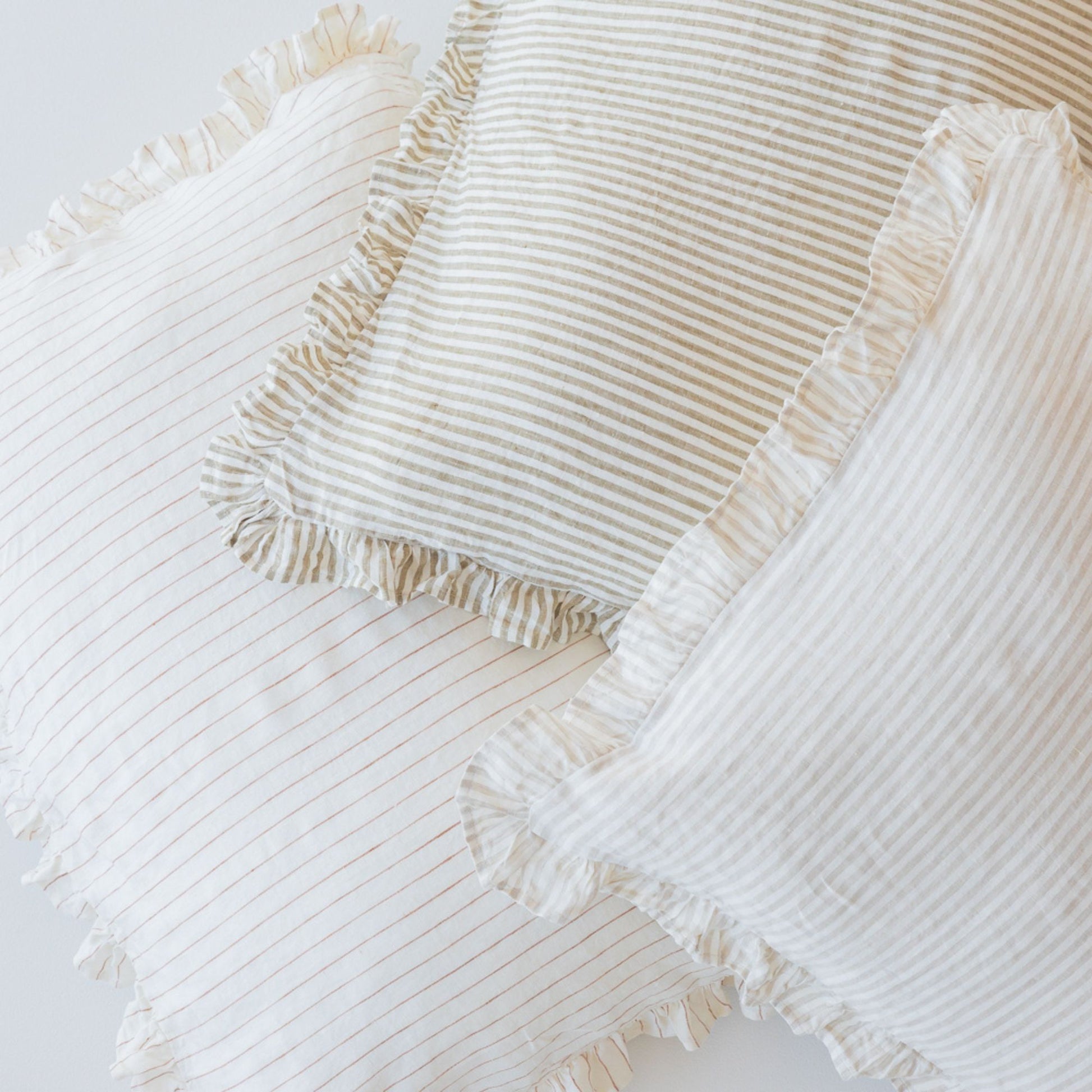 Foxtrot Home French Flax Linen styled in a bedroom with Stripes Ruffles Cushion Covers