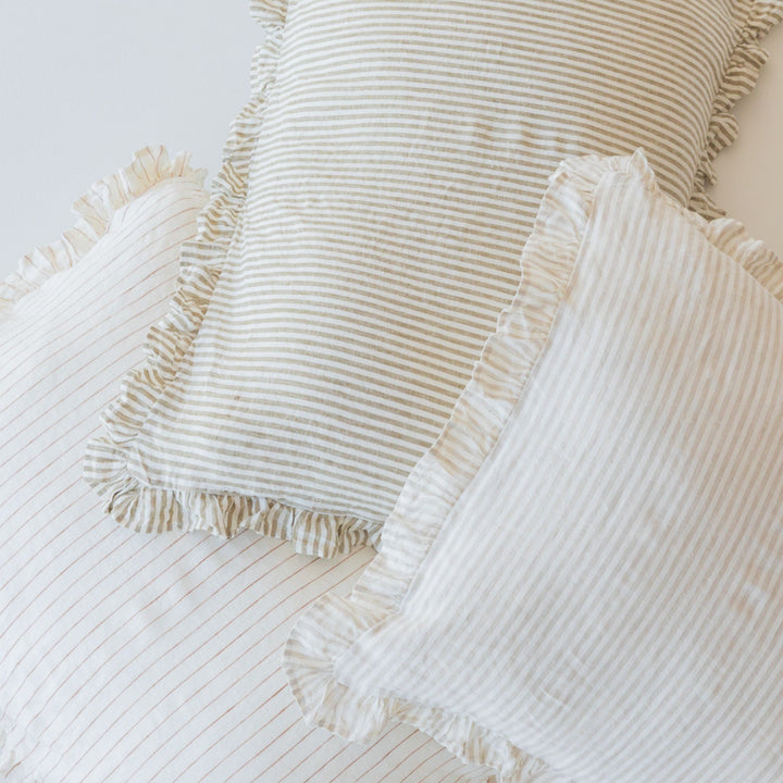 Foxtrot Home French Flax Linen styled in a bedroom with a Tobacco Stripes Ruffles Cushion Cover