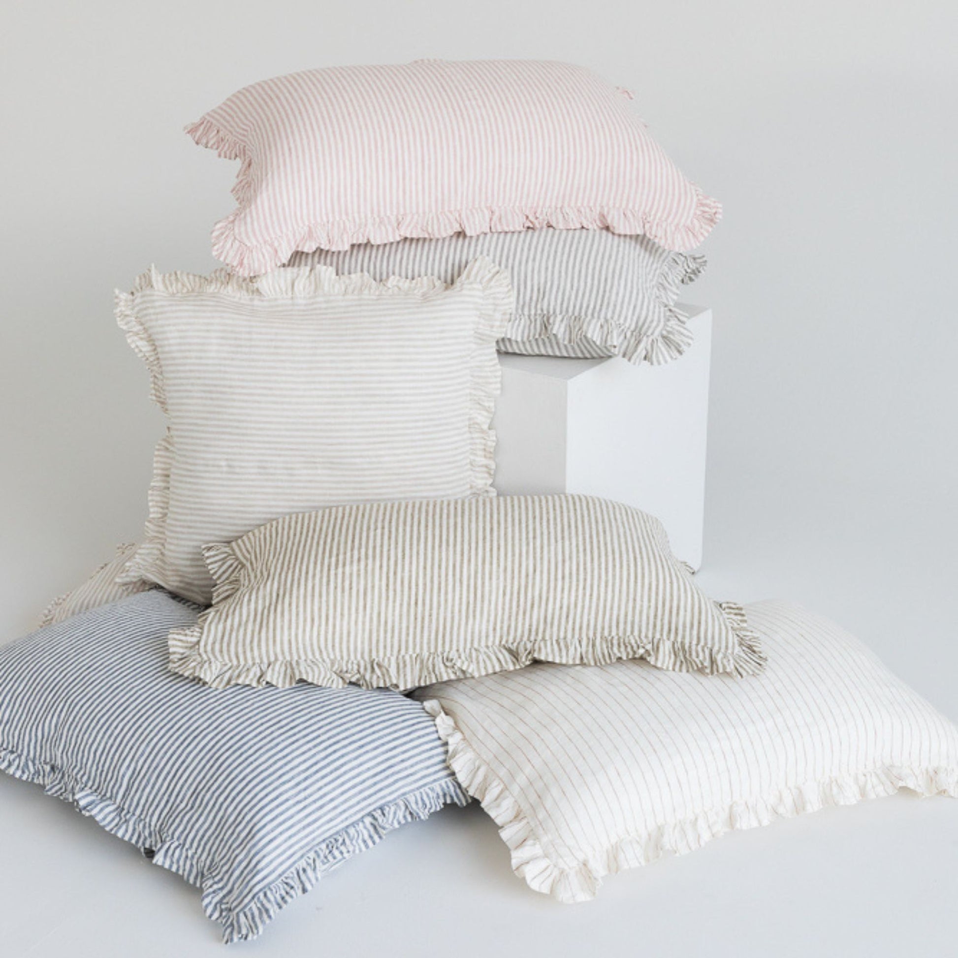 Foxtrot Home French Flax Linen styled in a bedroom with Stripes Ruffles Cushion Covers