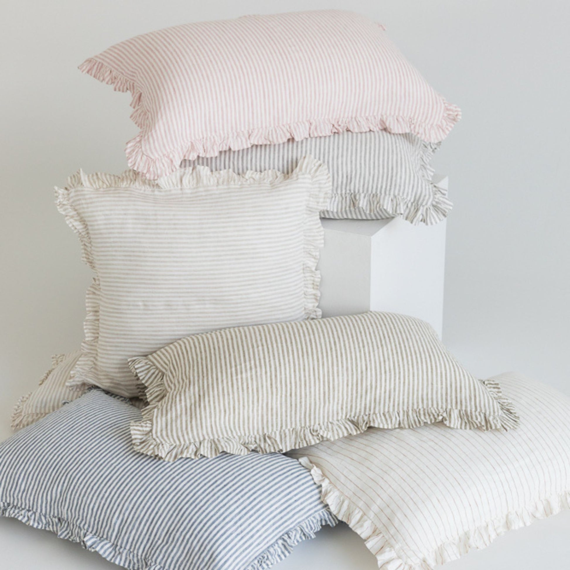 Foxtrot Home French Flax Linen styled in a bedroom with Stripes Ruffles Cushion Covers