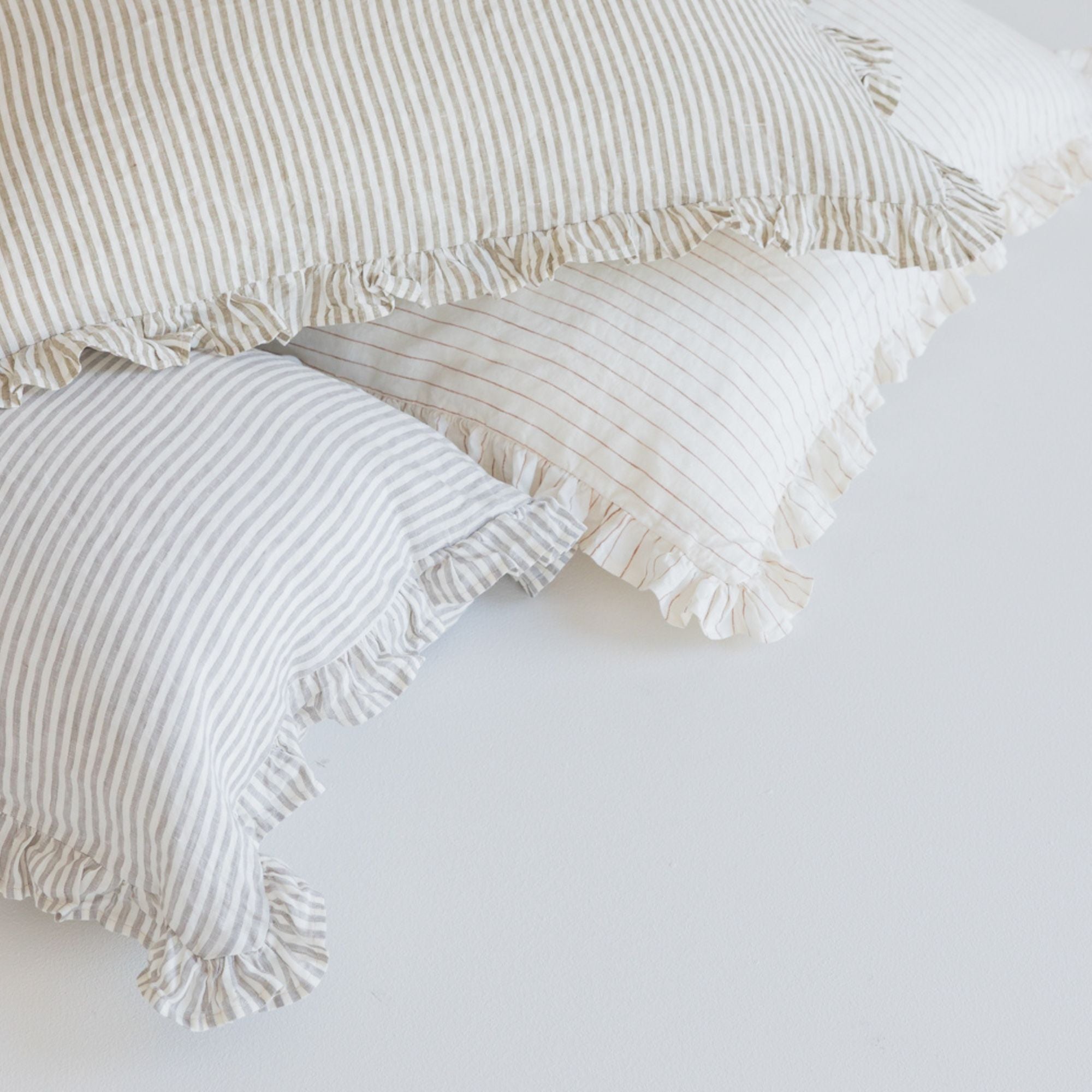 Foxtrot Home French Flax Linen styled in a bedroom with Stripes Ruffles Cushion Covers