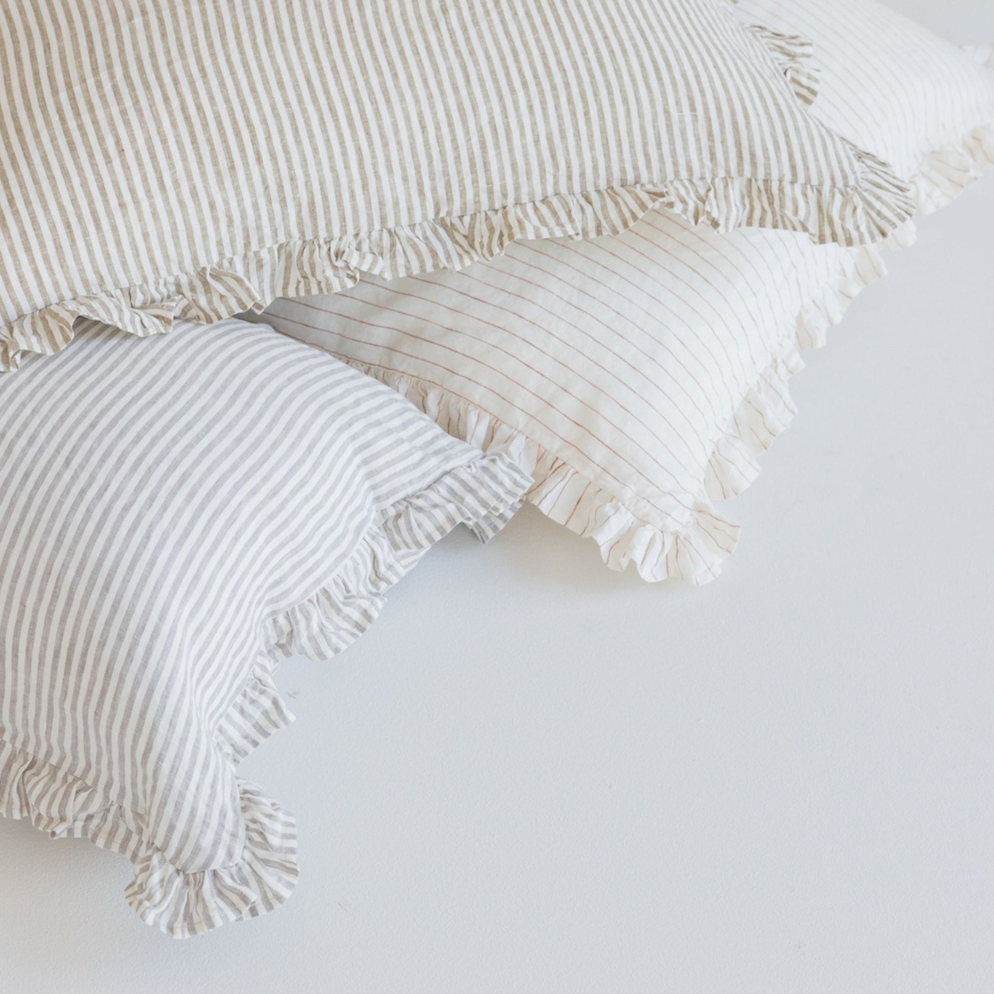 Foxtrot Home French Flax Linen styled in a bedroom with Stripes Ruffles Cushion Covers
