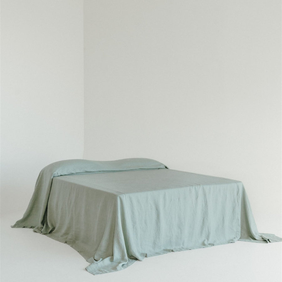 Foxtrot Home French Flax Linen styled in a bedroom with a Sage Green Bedspread