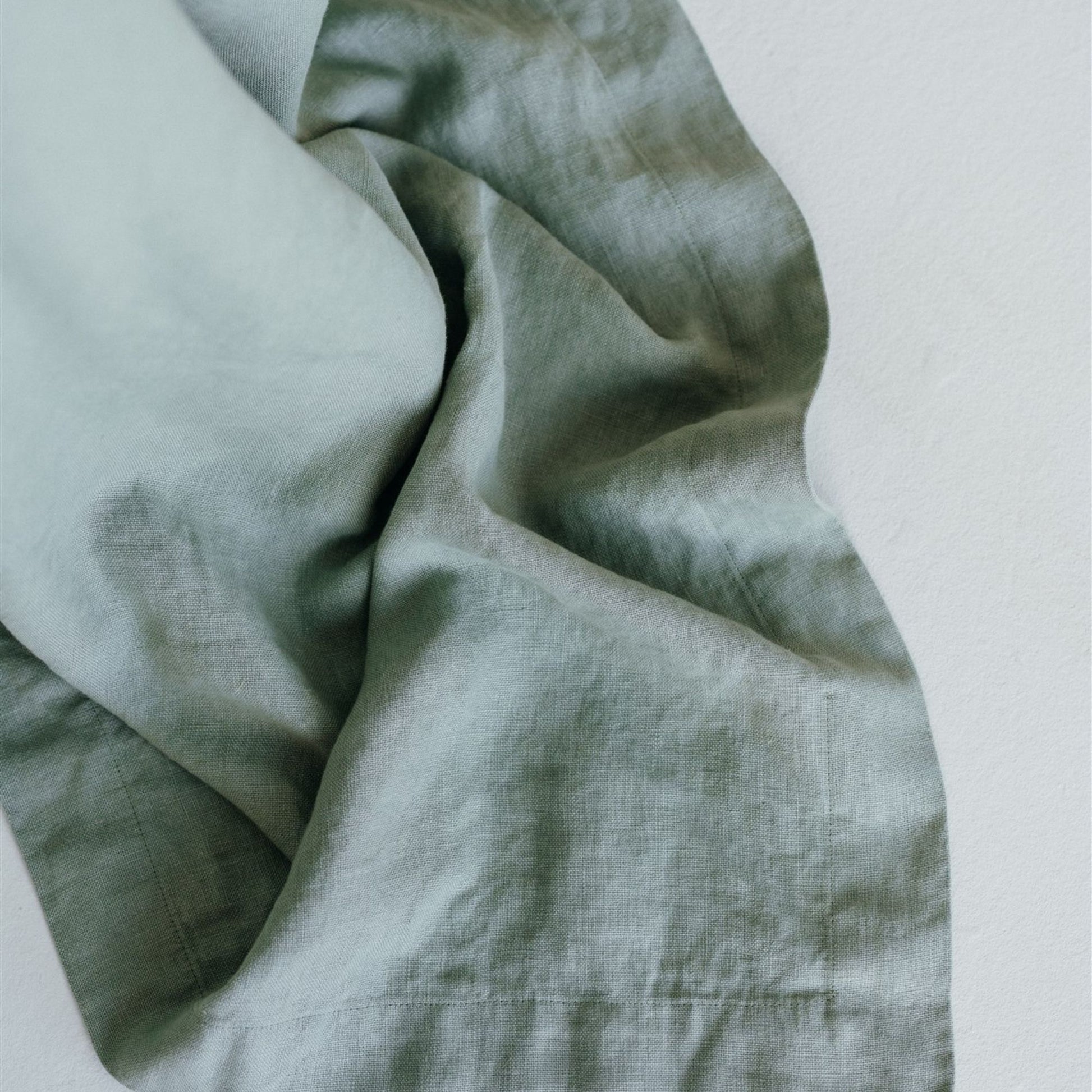 Foxtrot Home French Flax Linen styled in a bedroom with a Sage Green Bedspread