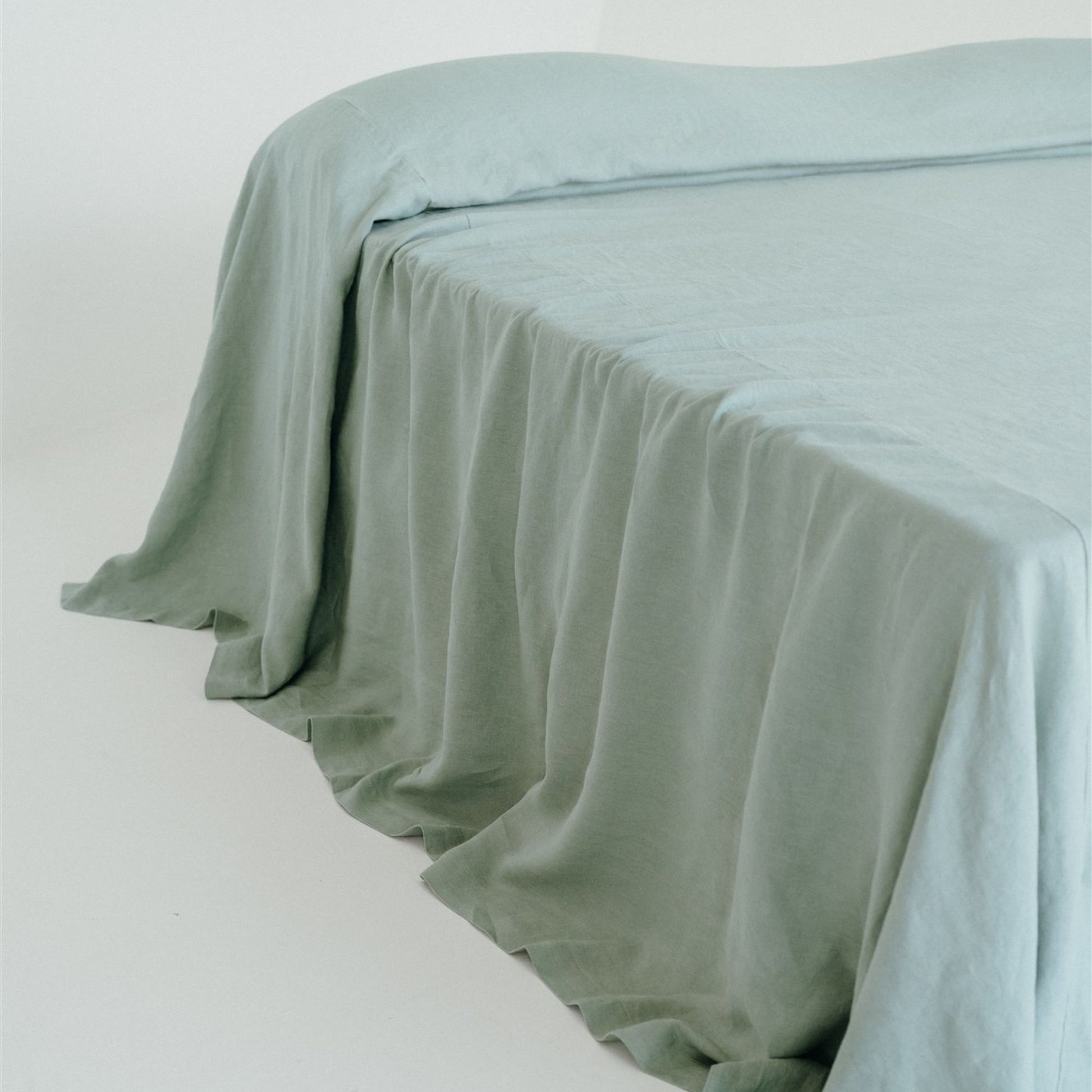 Foxtrot Home French Flax Linen styled in a bedroom with a Sage Green Bedspread