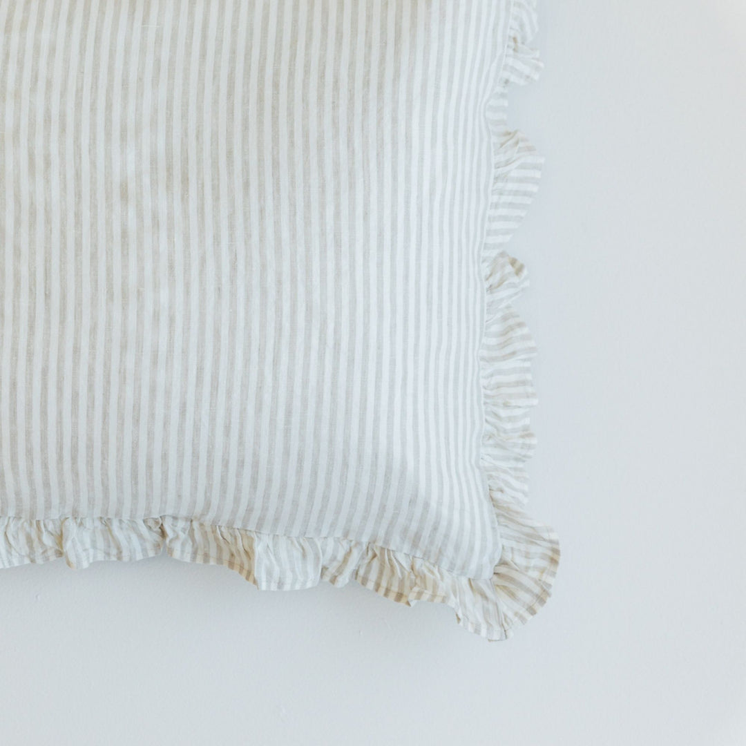 Foxtrot Home French Flax Linen styled in a bedroom with a Sand Stripes Ruffles Cushion Cover