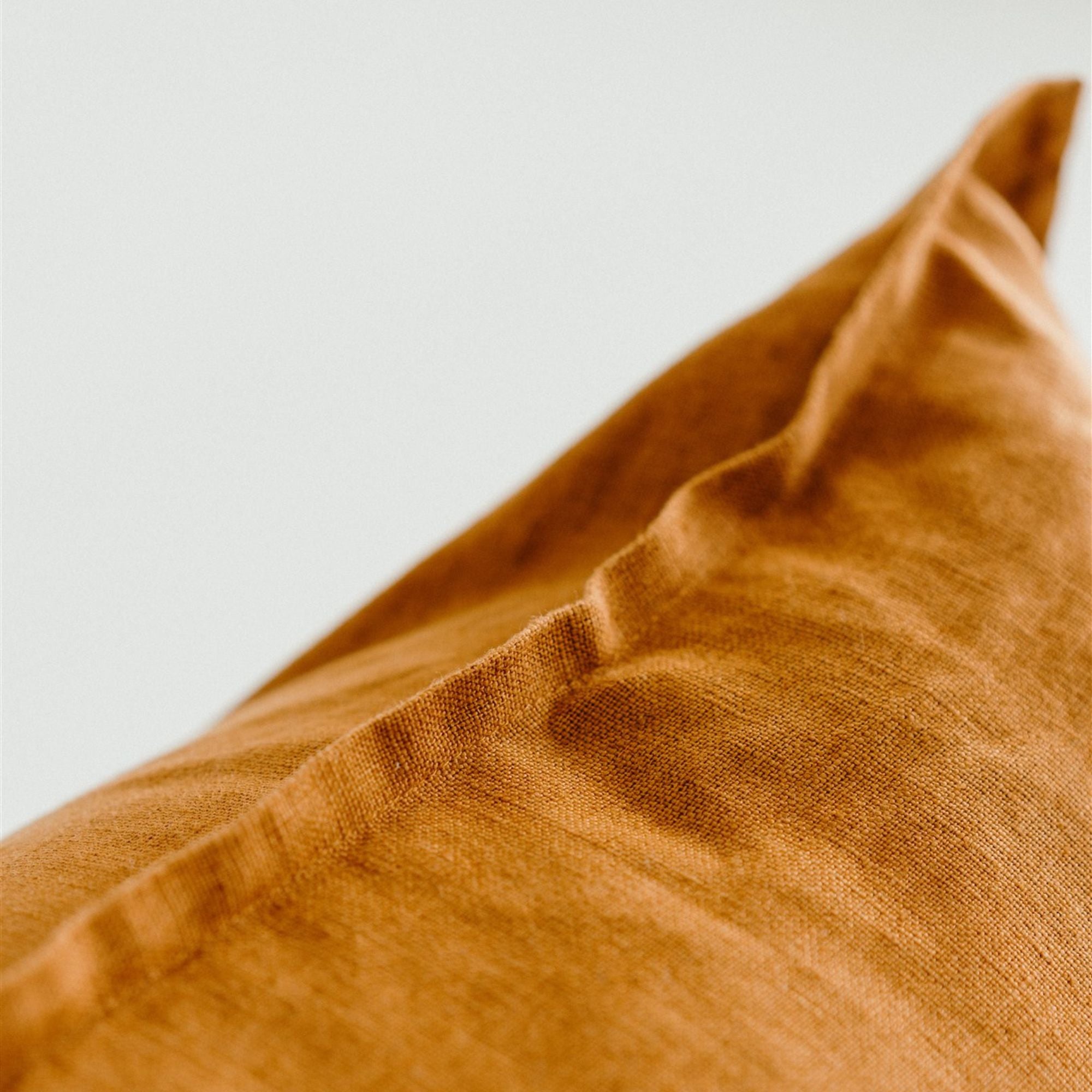 Foxtrot Home French Flax Linen styled with a Tobacco Cushion