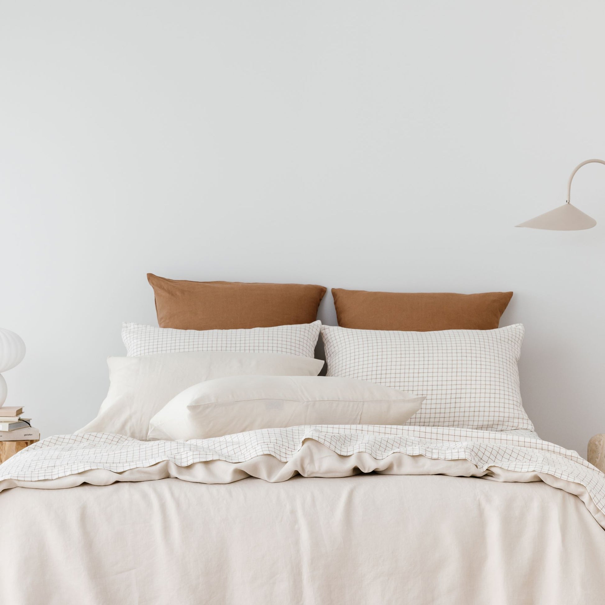 Foxtrot Home French Flax Linen styled with a Malt Brown Grid Sheets and an Oat Duvet