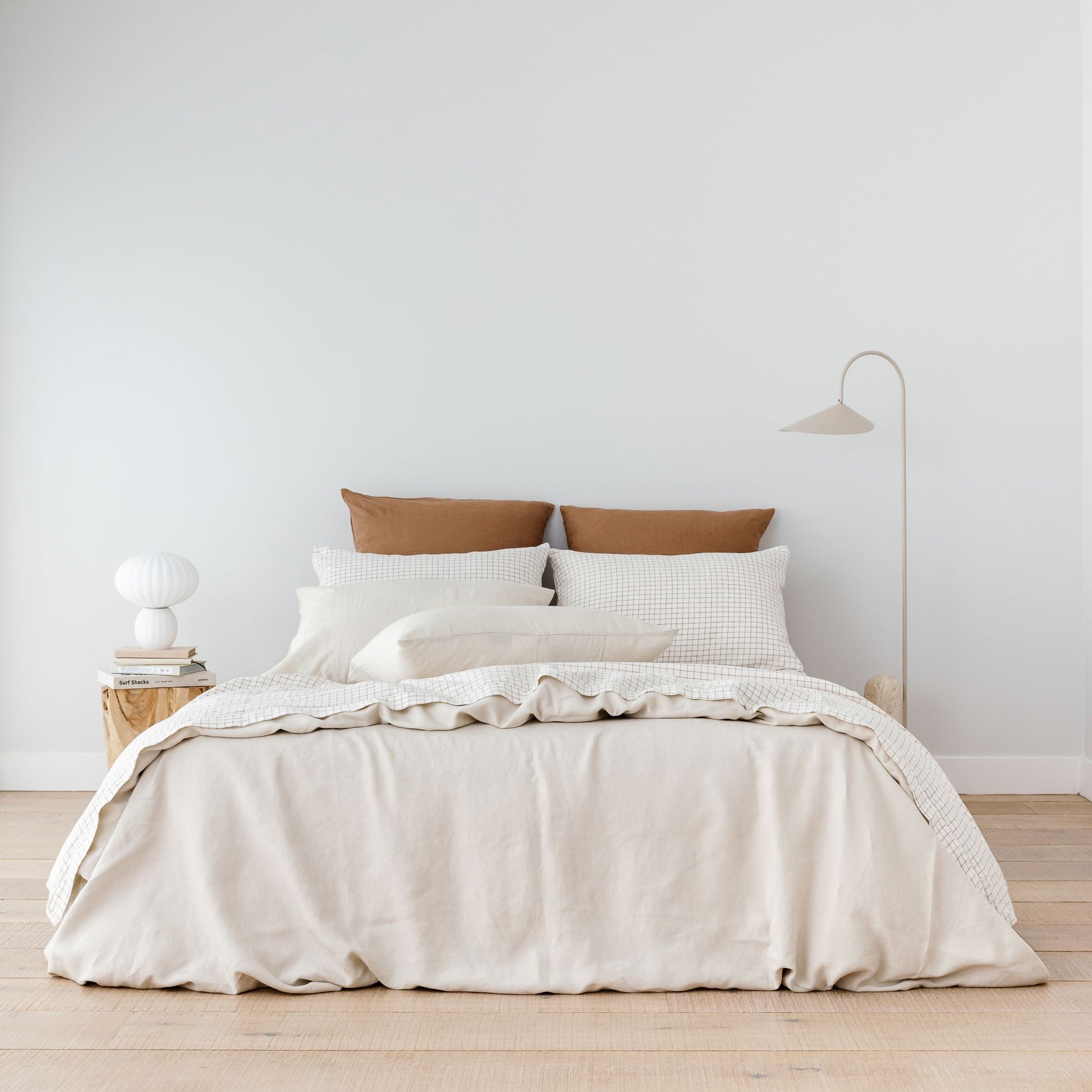 Foxtrot Home French Flax Linen styled with Malt Brown Grid Sheet Sets and an Oat Duvet